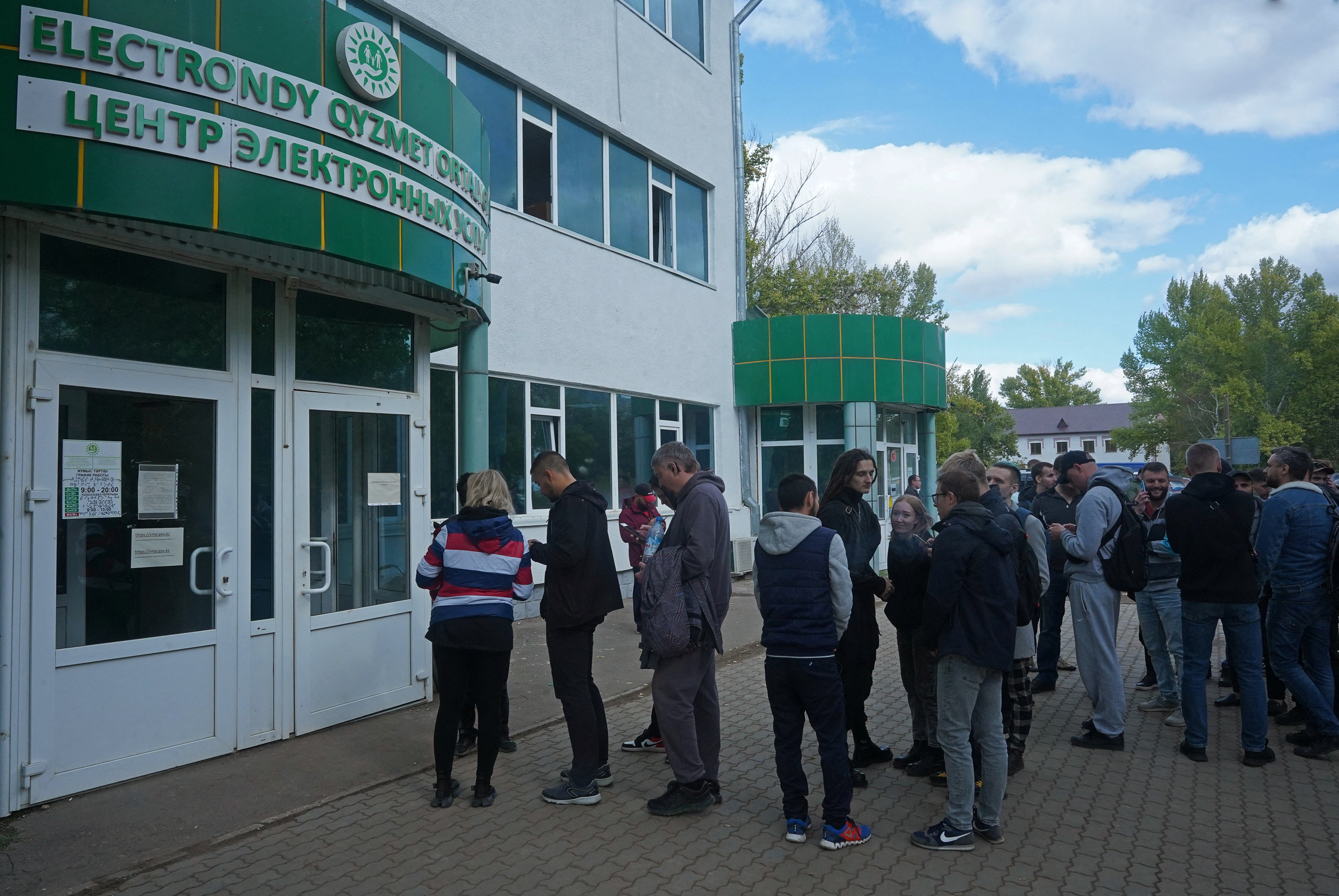 Russian citizens queue outside a public service centre in Oral