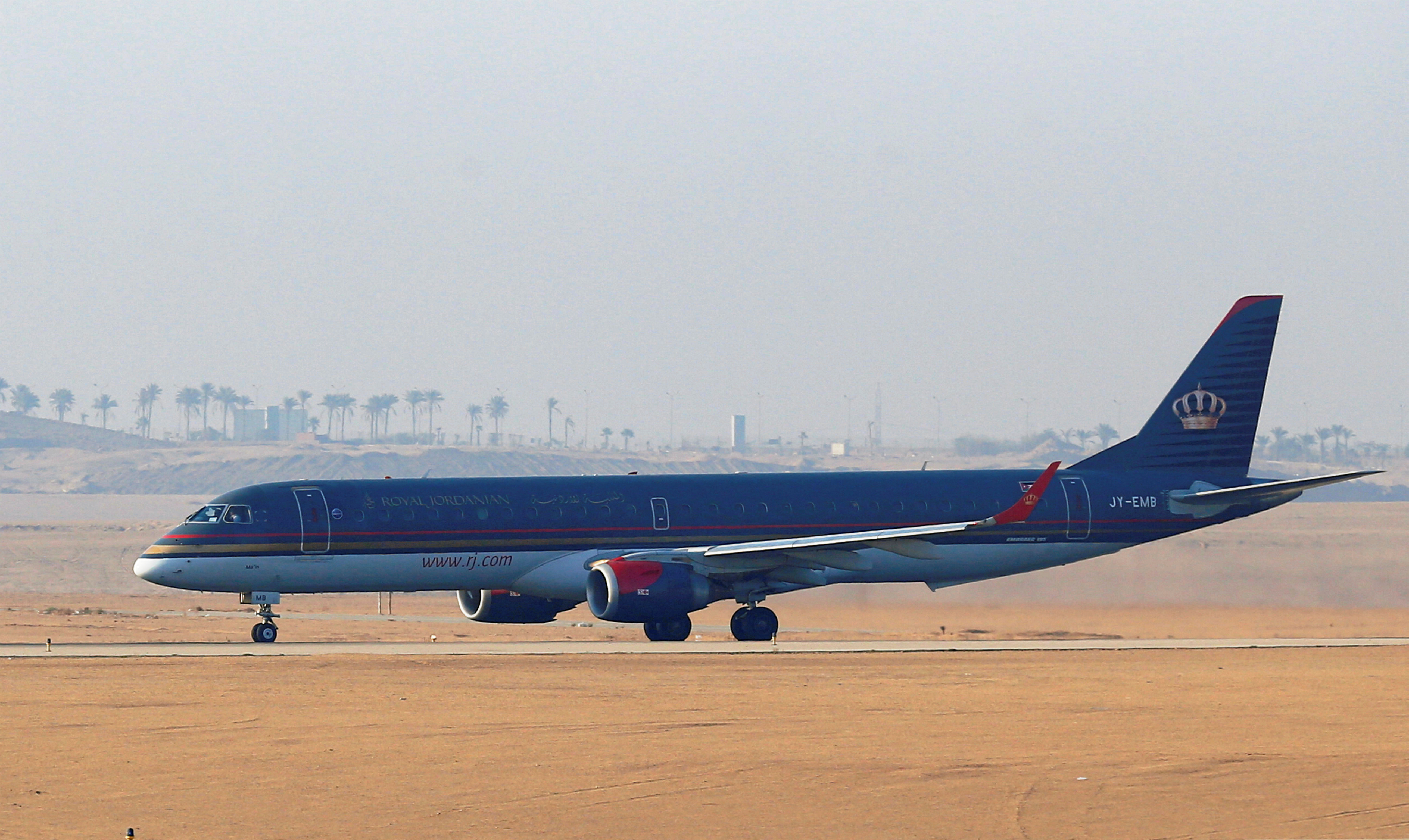 A Royal Jordanian Airlines Embraer	ERJ-195AR plane waits to take off on the runway at Cairo Airport