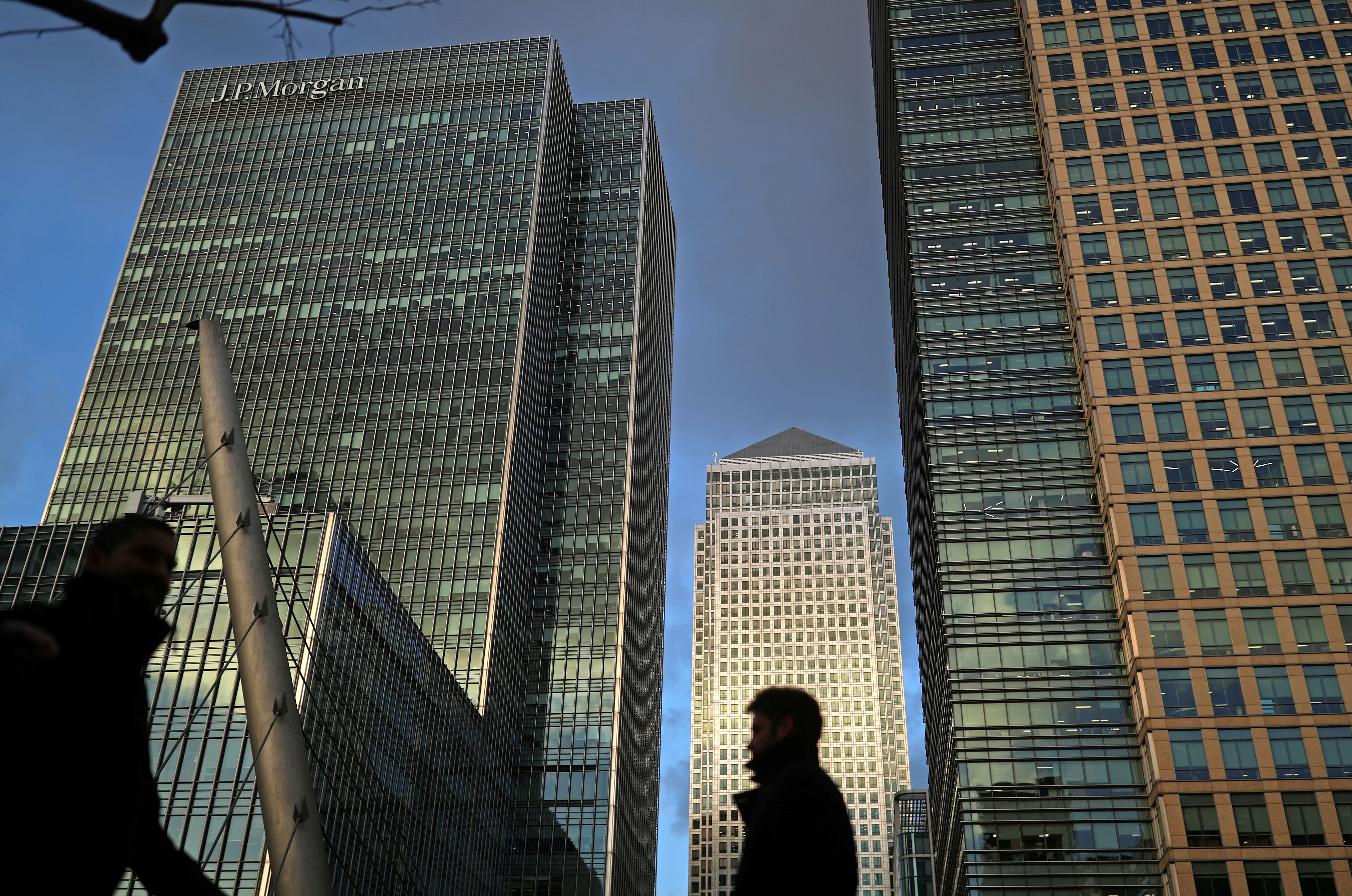 People walk through the Canary Wharf financial district of London