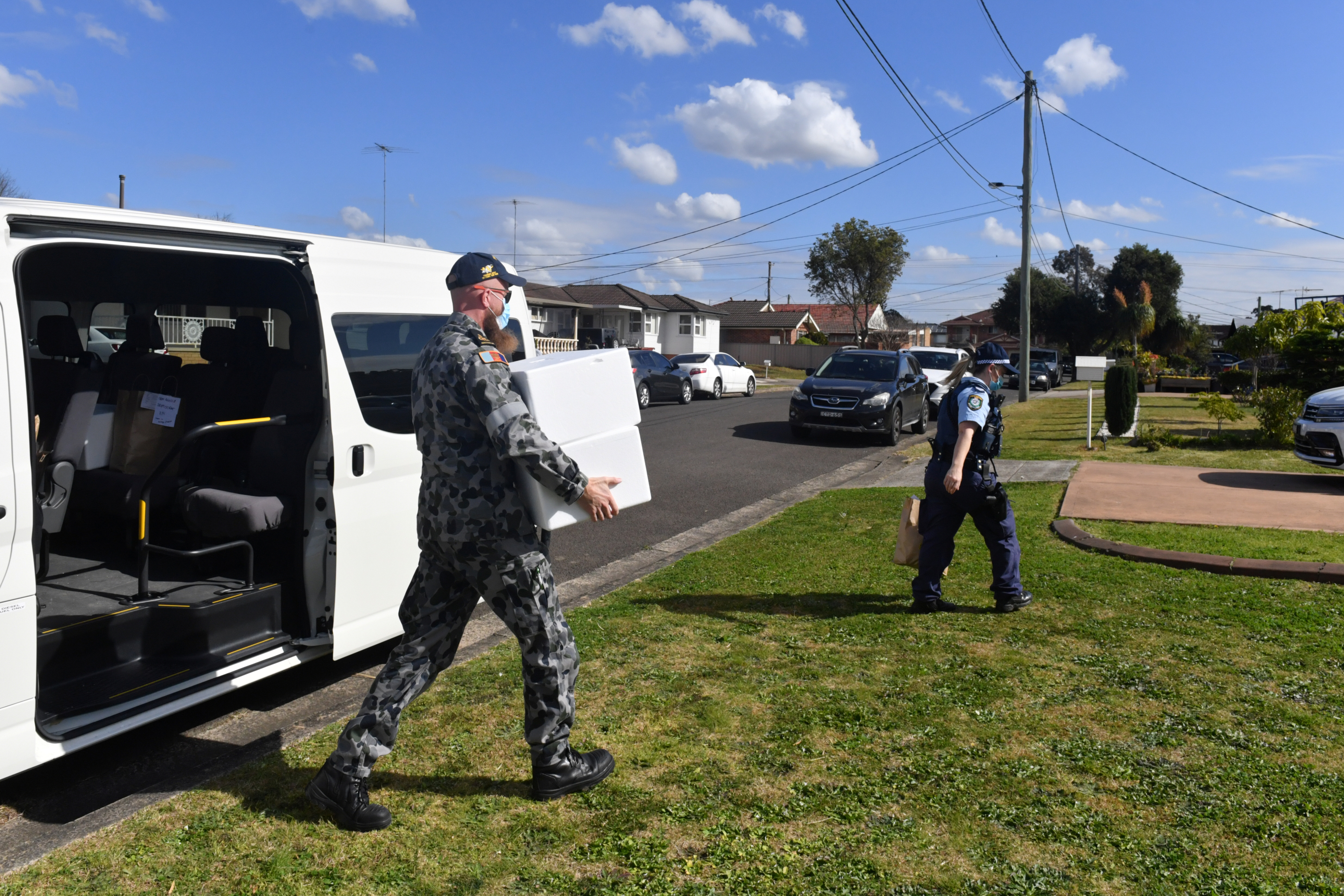 Defence Force personnel and NSW police deliver food to people in a COVID-19 lockdown in Sydney