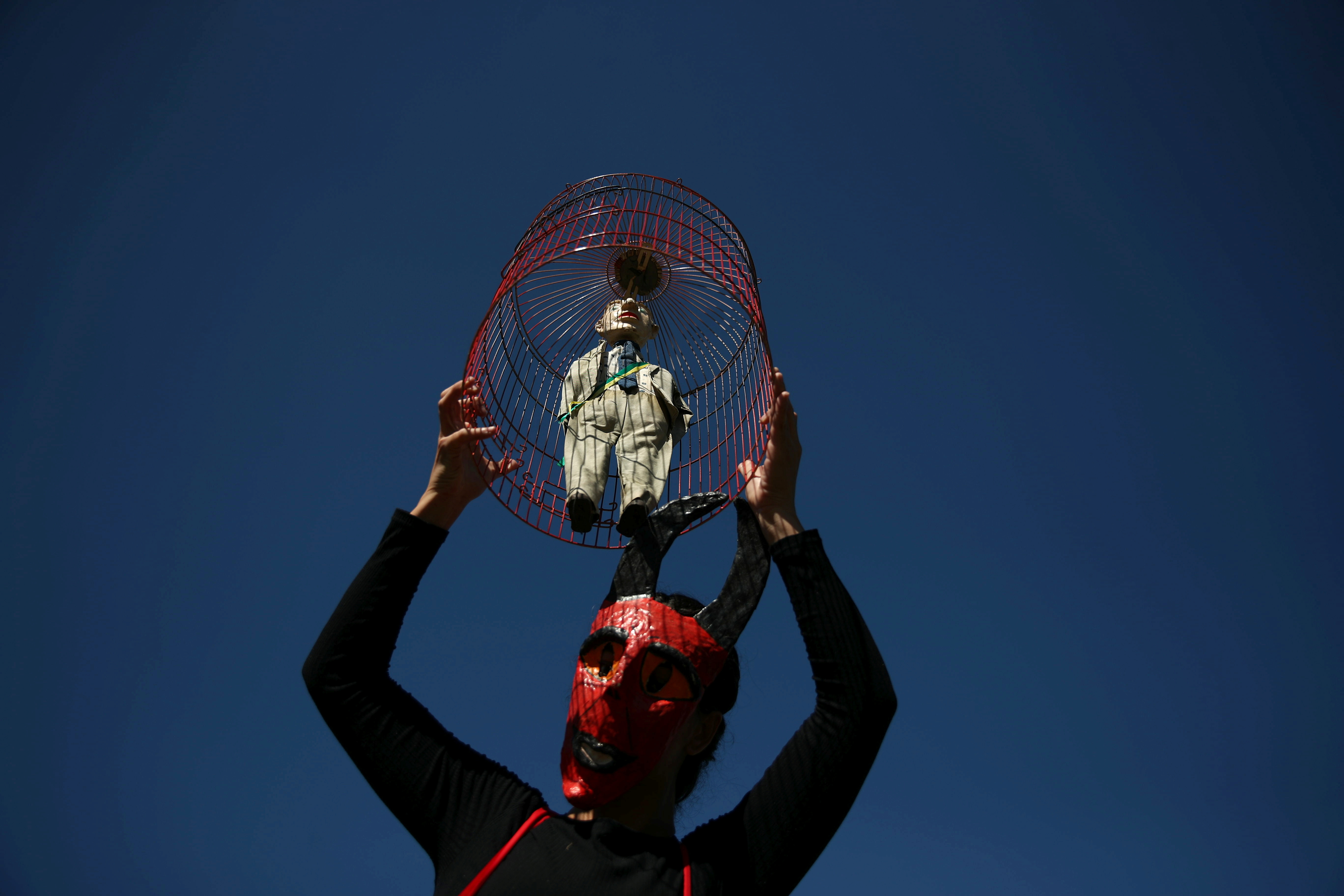 A protestor holds a puppet depicting Brazil's President Jair Bolsonaro during a demonstration against his handling of the coronavirus disease (COVID-19) pandemic and demanding his impeachment, in Rio de Janeiro, Brazil, July 24, 2021. REUTERS/Ricardo Moraes