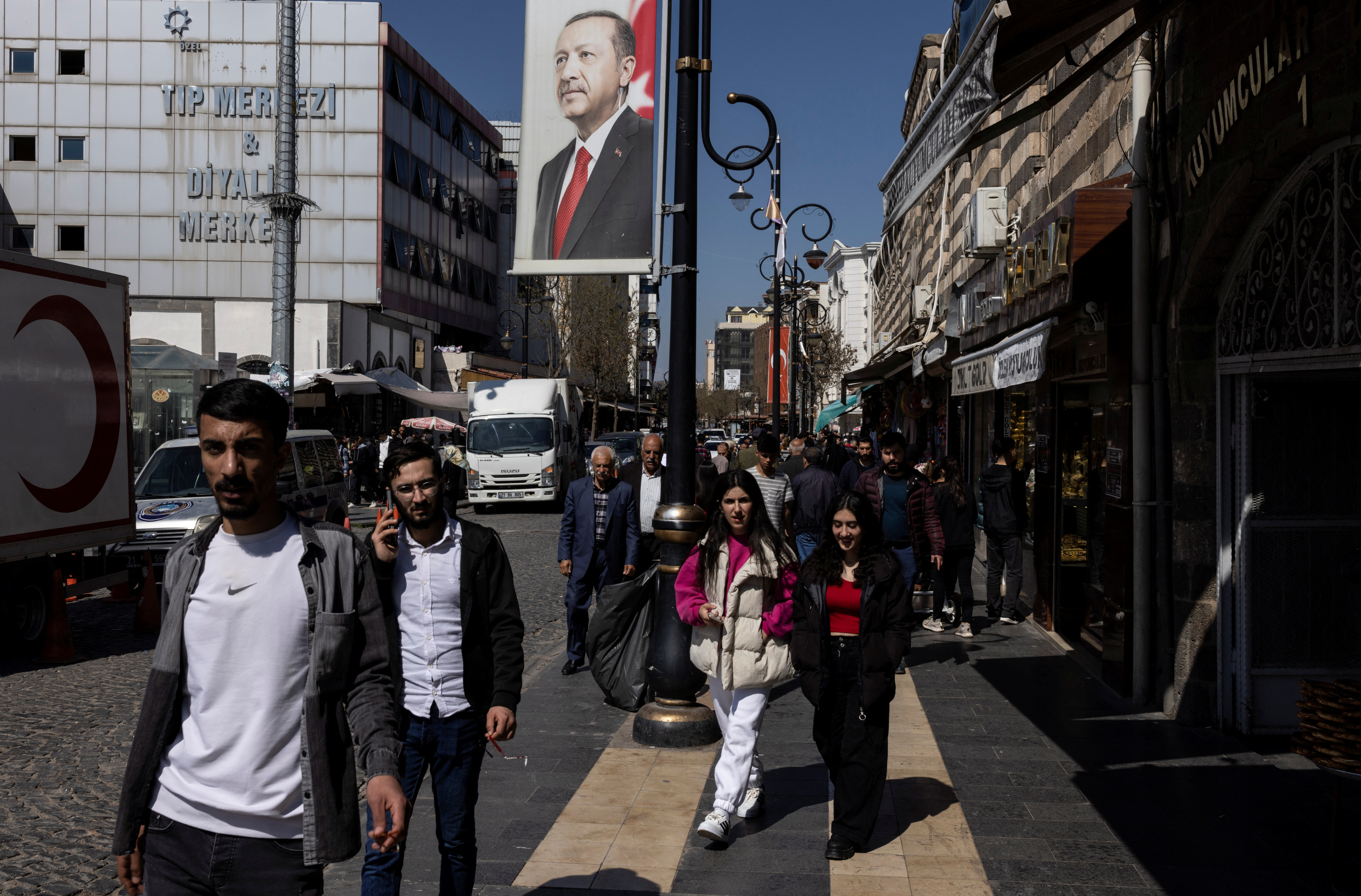 People walk along a main street in Diyarbakir