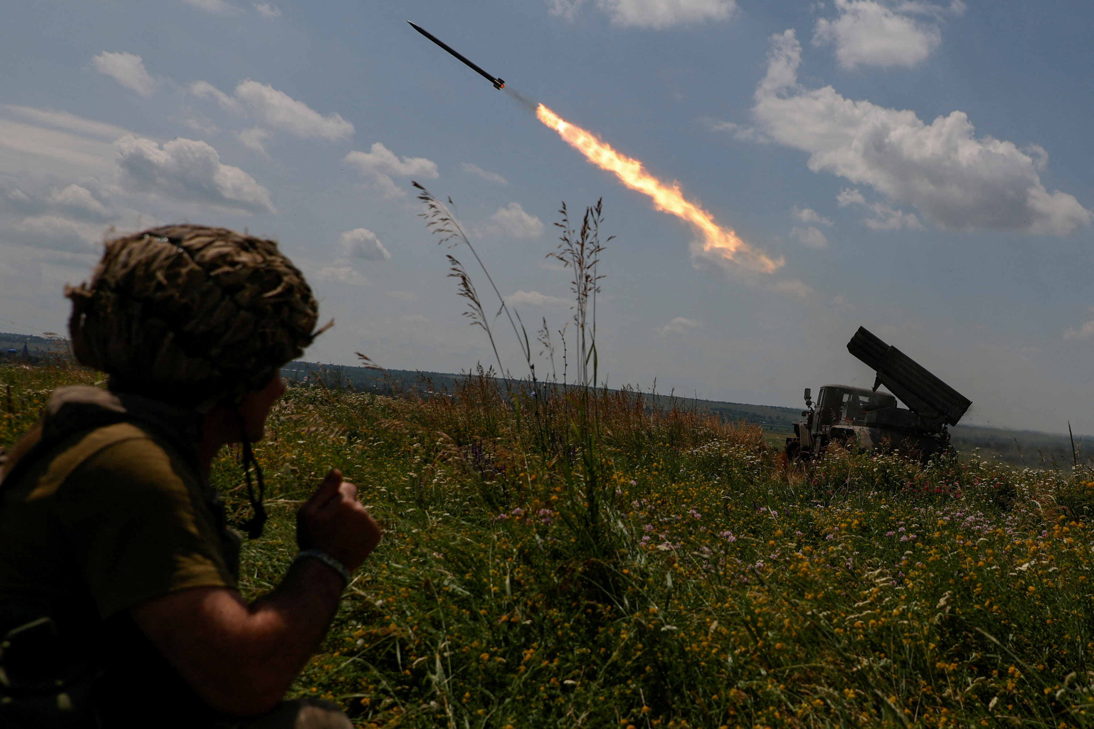 Ukrainian servicemen fire a BM-21 Grad multiple launch rocket system towards Russian troops near a front line in Zaporizhzhia region