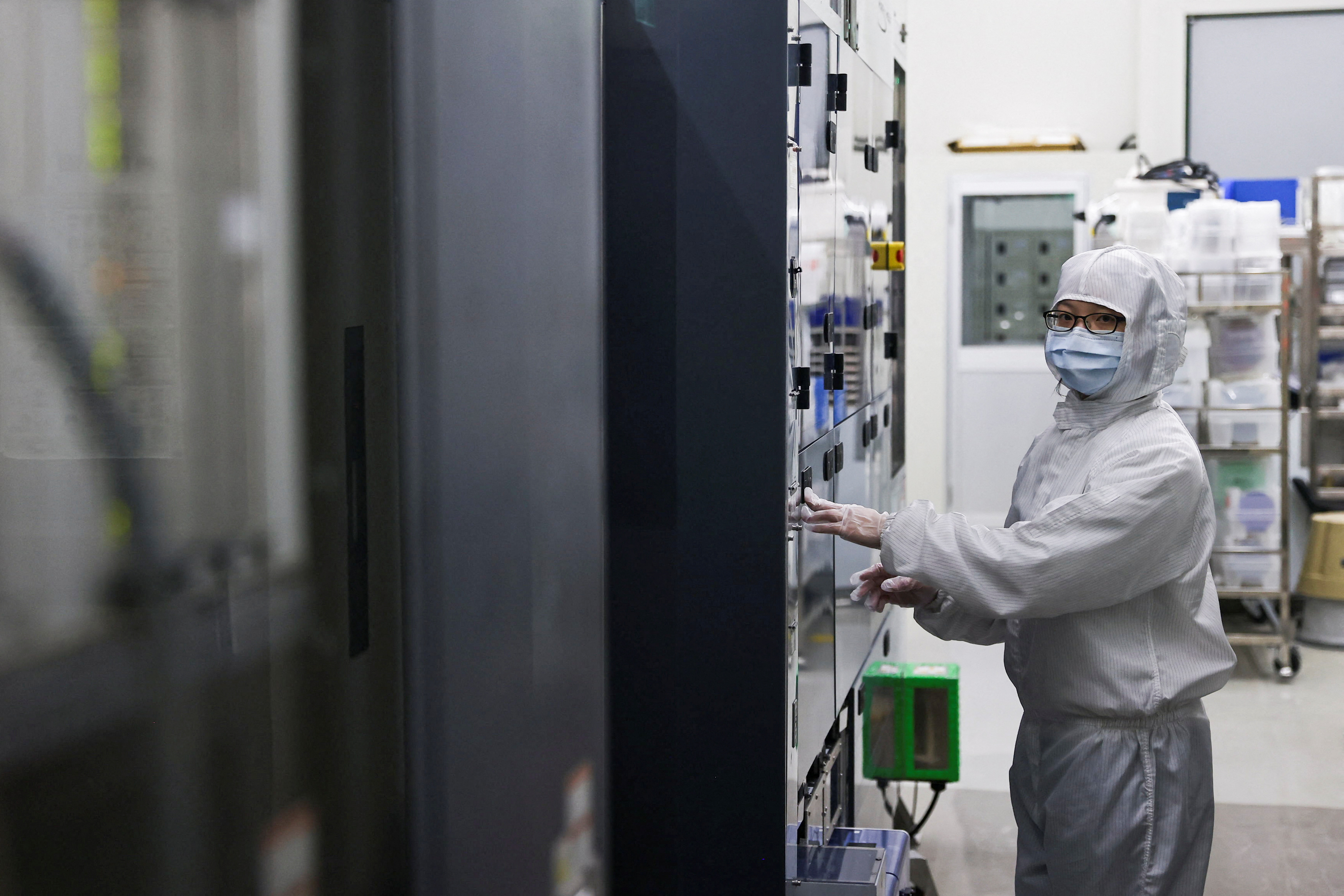 Huang Ya-Qi, an engineer who took classes and conducts her research at the Taiwan Semiconductor Research Institute (TSRI) poses for a photo inside a cleanroom in Hsinchu