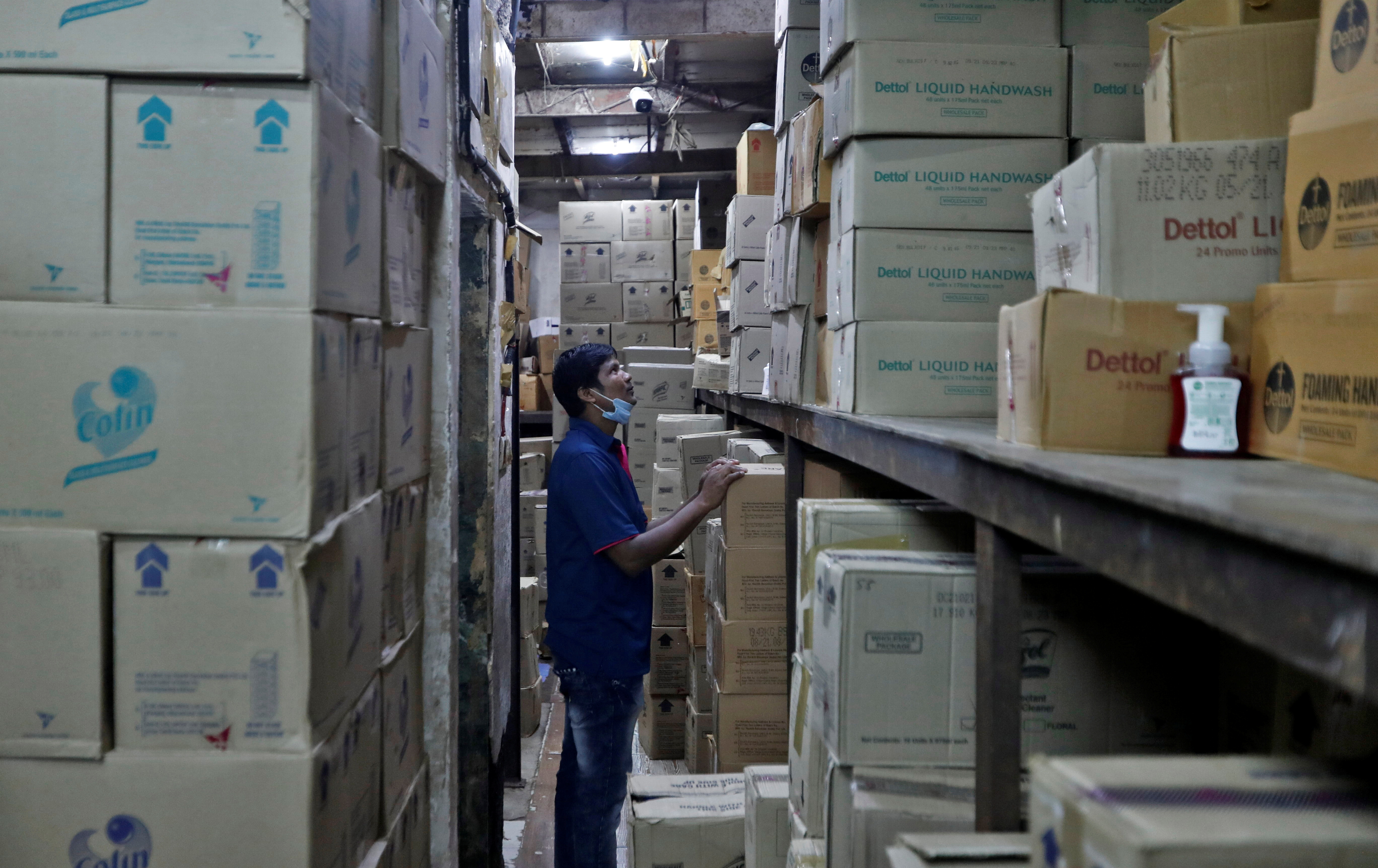 A worker inspects boxes of Reckitt's Dettol handwash at a distributor?s warehouse before loading them onto a truck for delivery to retailers in Mumbai, India, September 17, 2021. Picture taken September 17, 2021 REUTERS/Francis Mascarenhas