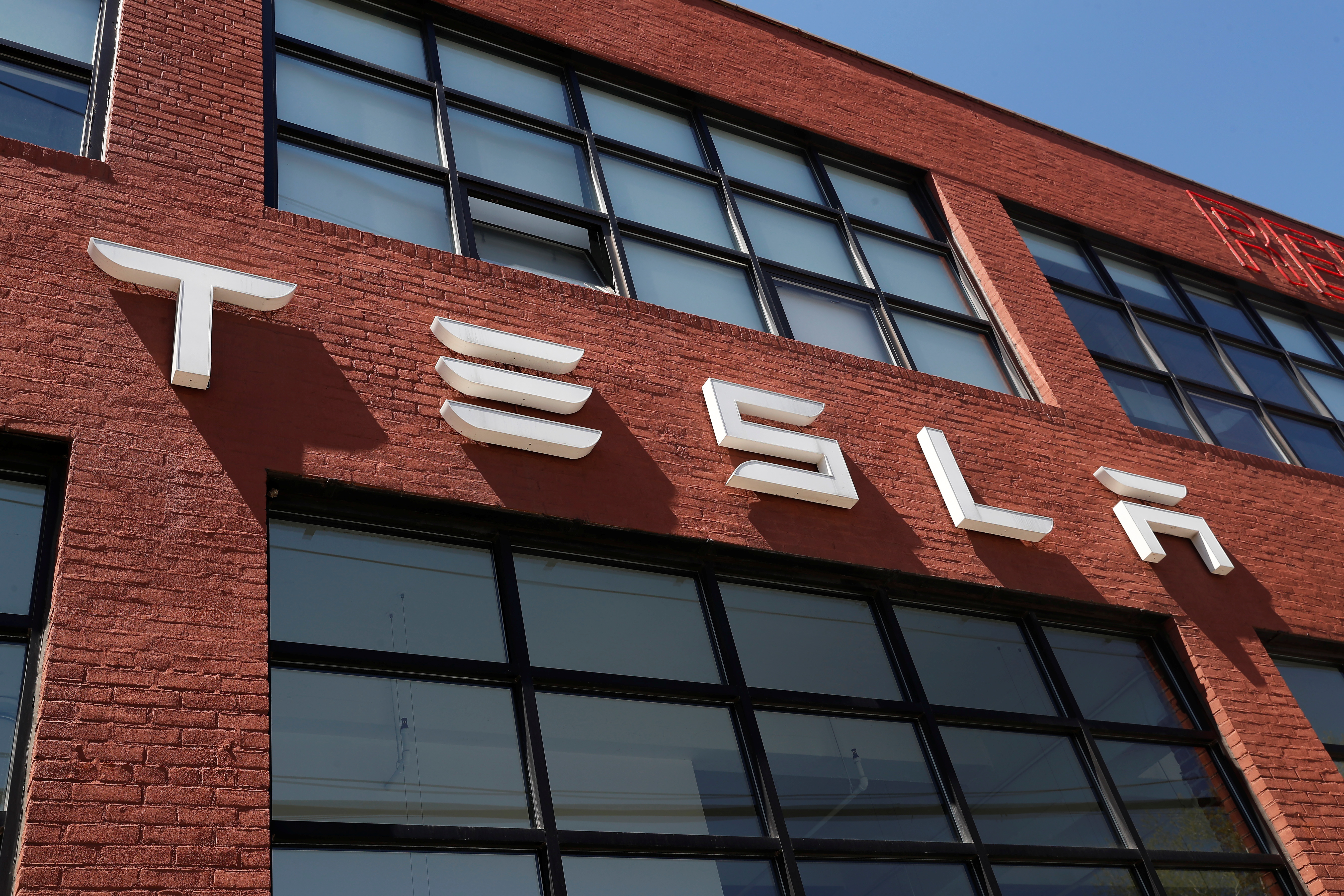 The TESLA logo is seen outside a dealership in the Brooklyn borough of New York City