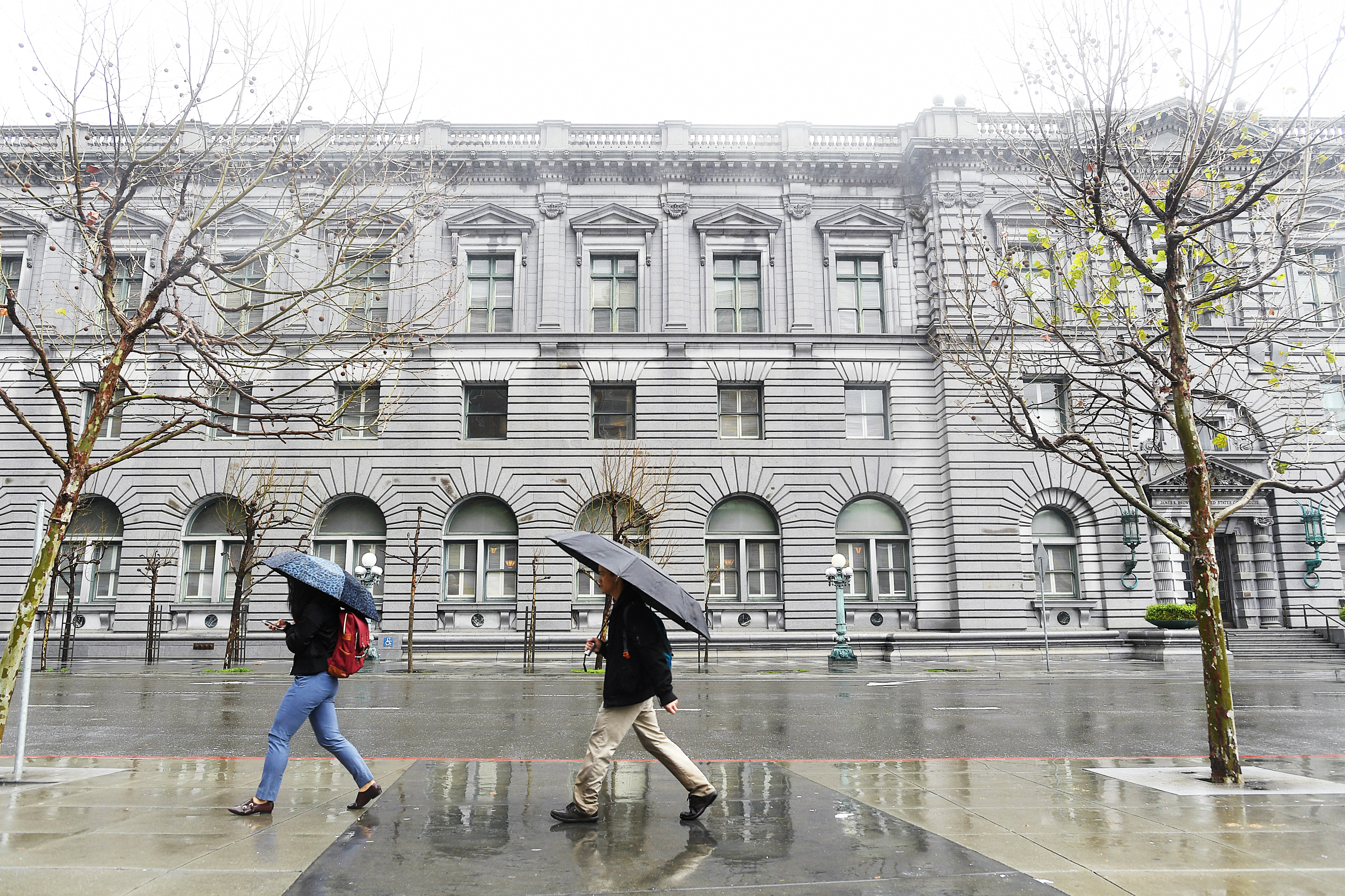 Pedestrians pass the James R. Browning U.S. Court of Appeals Building, home of the 9th U.S. Circuit Court of Appeals, in San Francisco