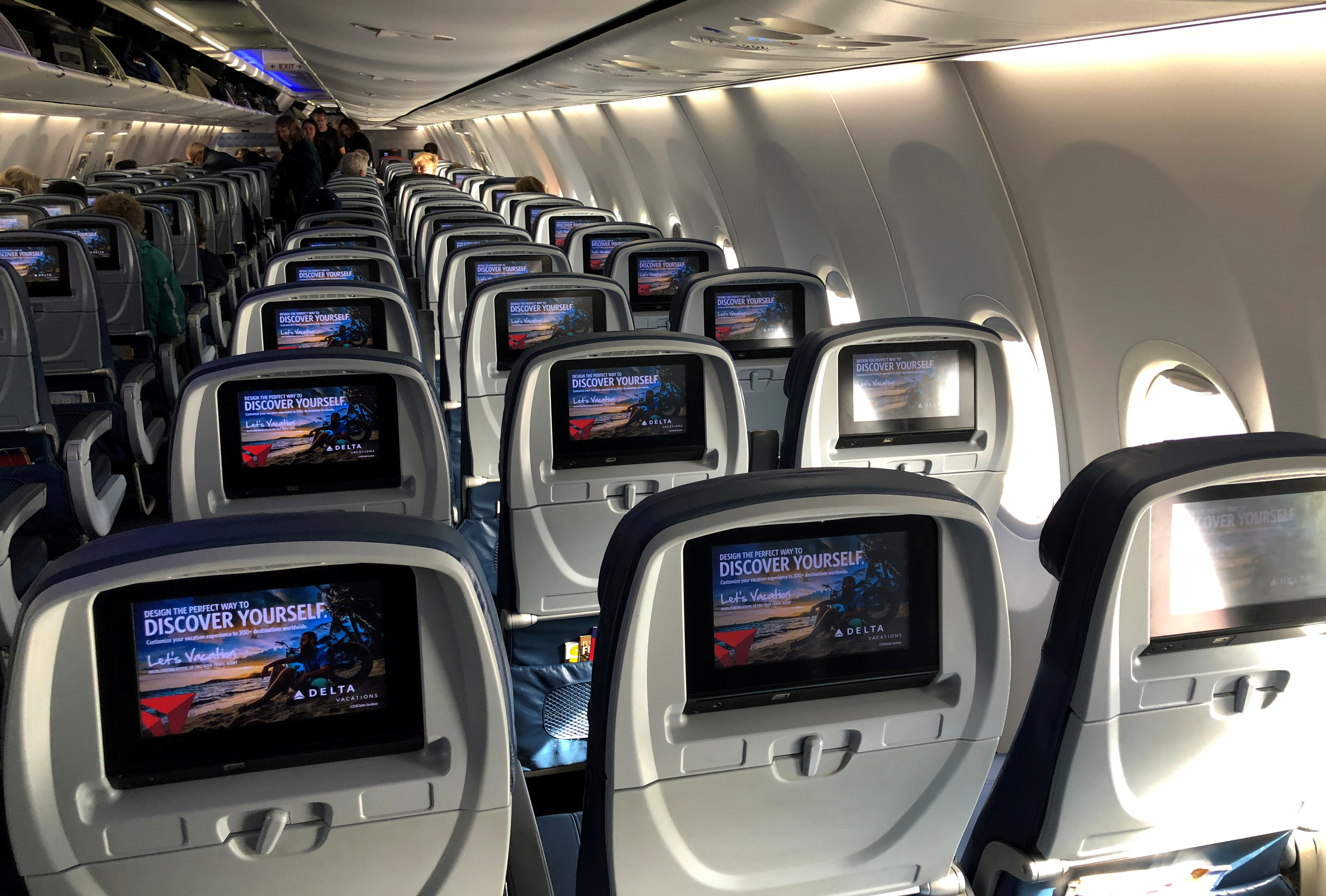 Video screens are shown built into the backs of passenger seats onboard a Delta Airlines Boeing 737-900ER aircraft in San Diego