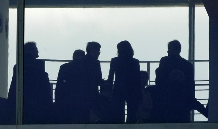 Figures of people are silhouetted as they gather in the Chancellery in Berlin