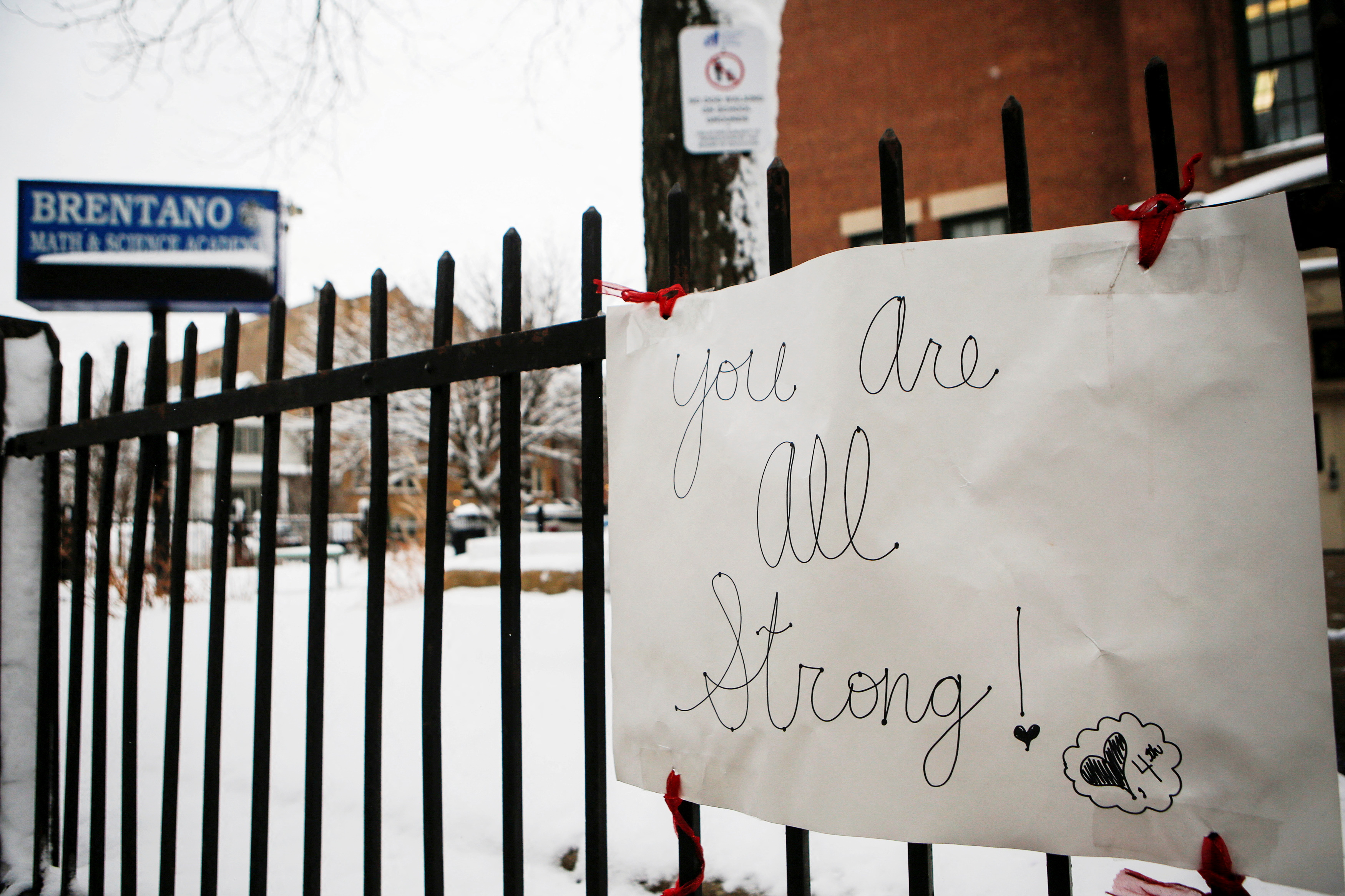 A sign from a teachers protest a few weeks ago remains on the fence of Brentano Elementary Math & Science Academy in Chicago's Logan Square neighborhood, as Chicago Public Schools suspended in-person learning after Chicago Teachers Union members voted to work remotely due to concerns around the coronavirus disease (COVID-19) precautions in Chicago, Illinois, U.S., January 27, 2021.  REUTERS/Eileen Meslar/File Photo