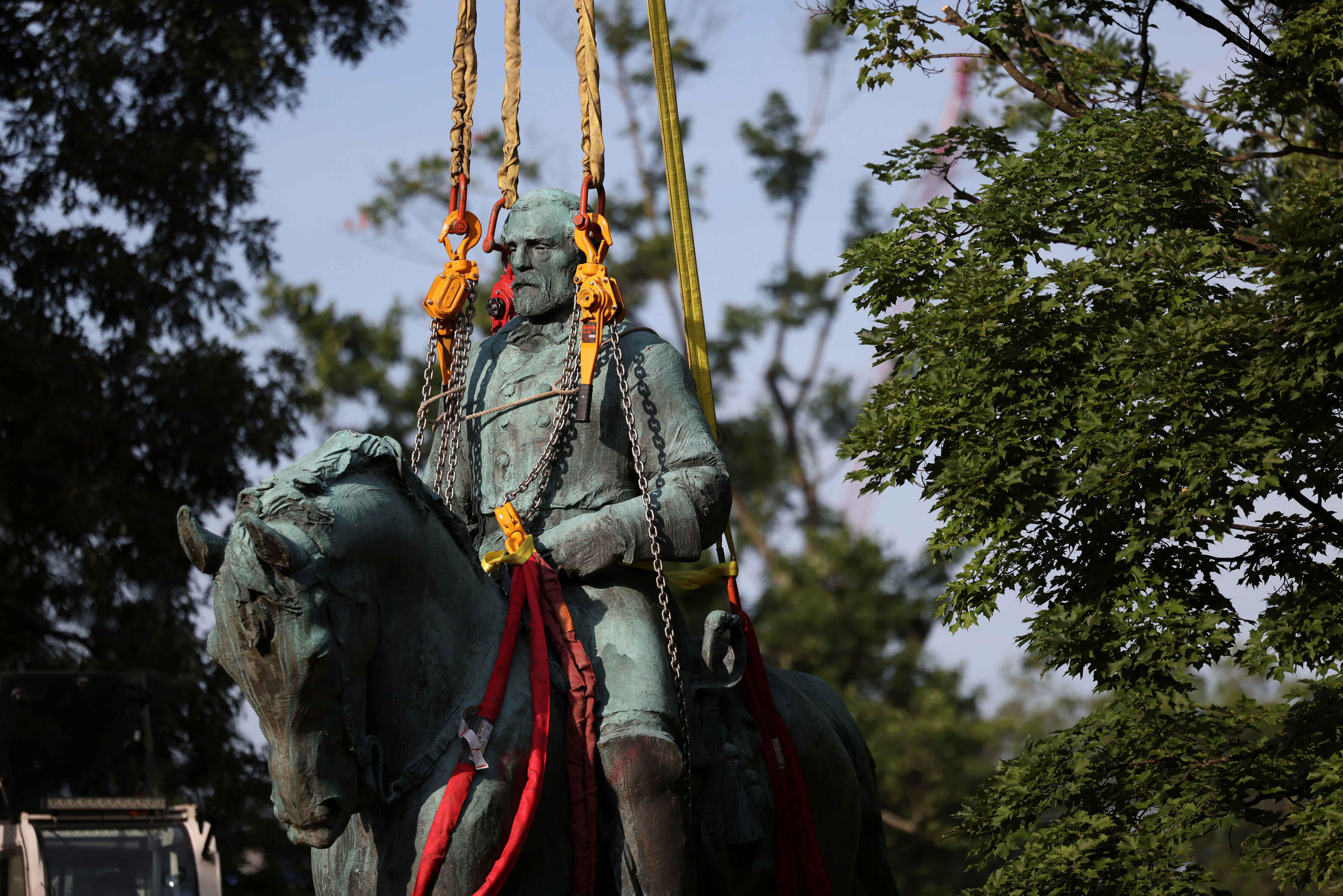 Workers remove a statue of Confederate General Robert E. Lee, in Charlottesville