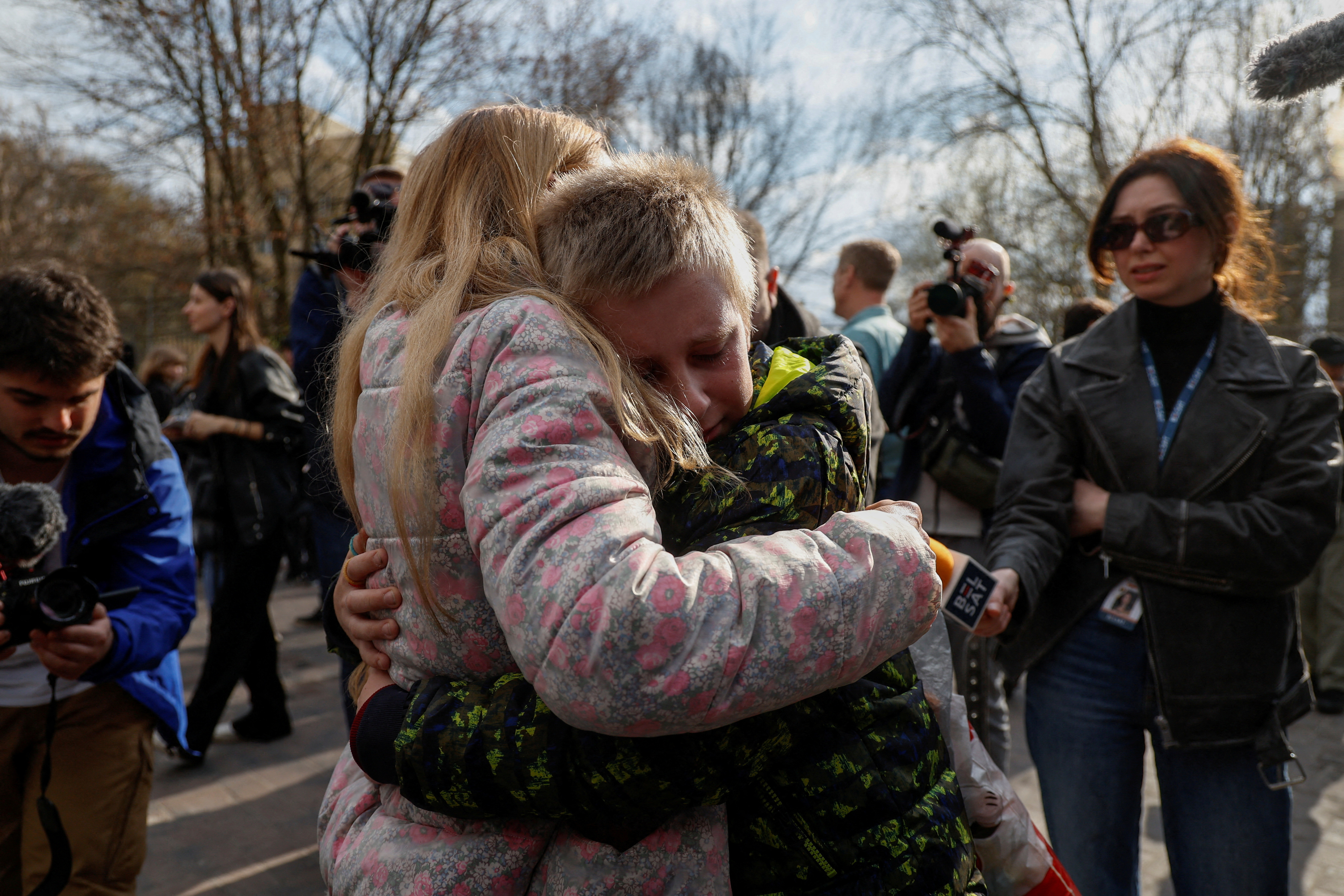 Iryna embraces her 13-year-old son Bohdan, who was taken to Russia, after he returned via the Ukraine-Belarus border, in Kyiv