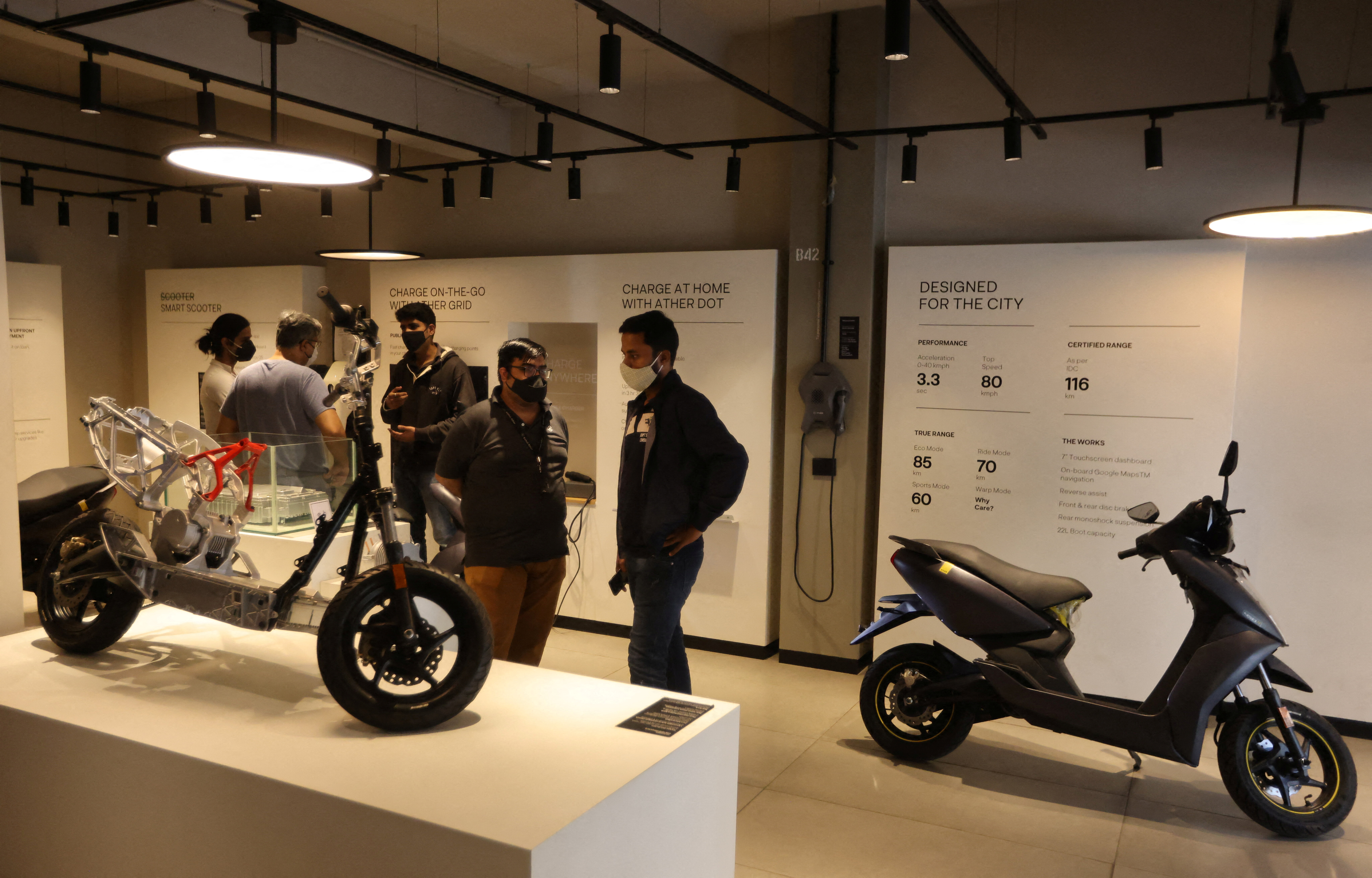 People look at electric scooters inside the Ather showroom in Mumbai