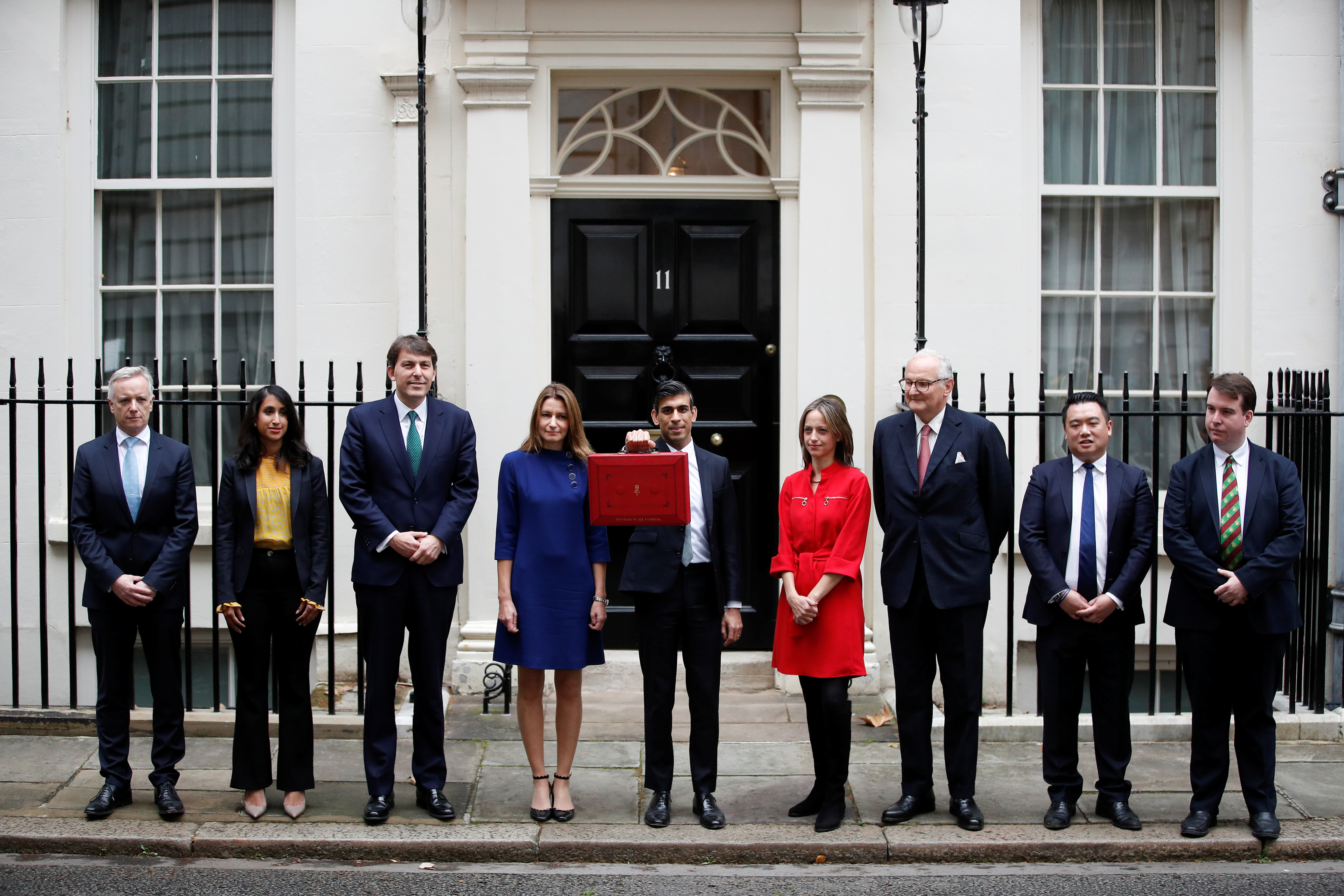 Britain's Chancellor of the Exchequer Rishi Sunak holds the budget box as he poses with his treasury team outside Downing Street in London, Britain, October 27, 2021. REUTERS/Peter Nicholls