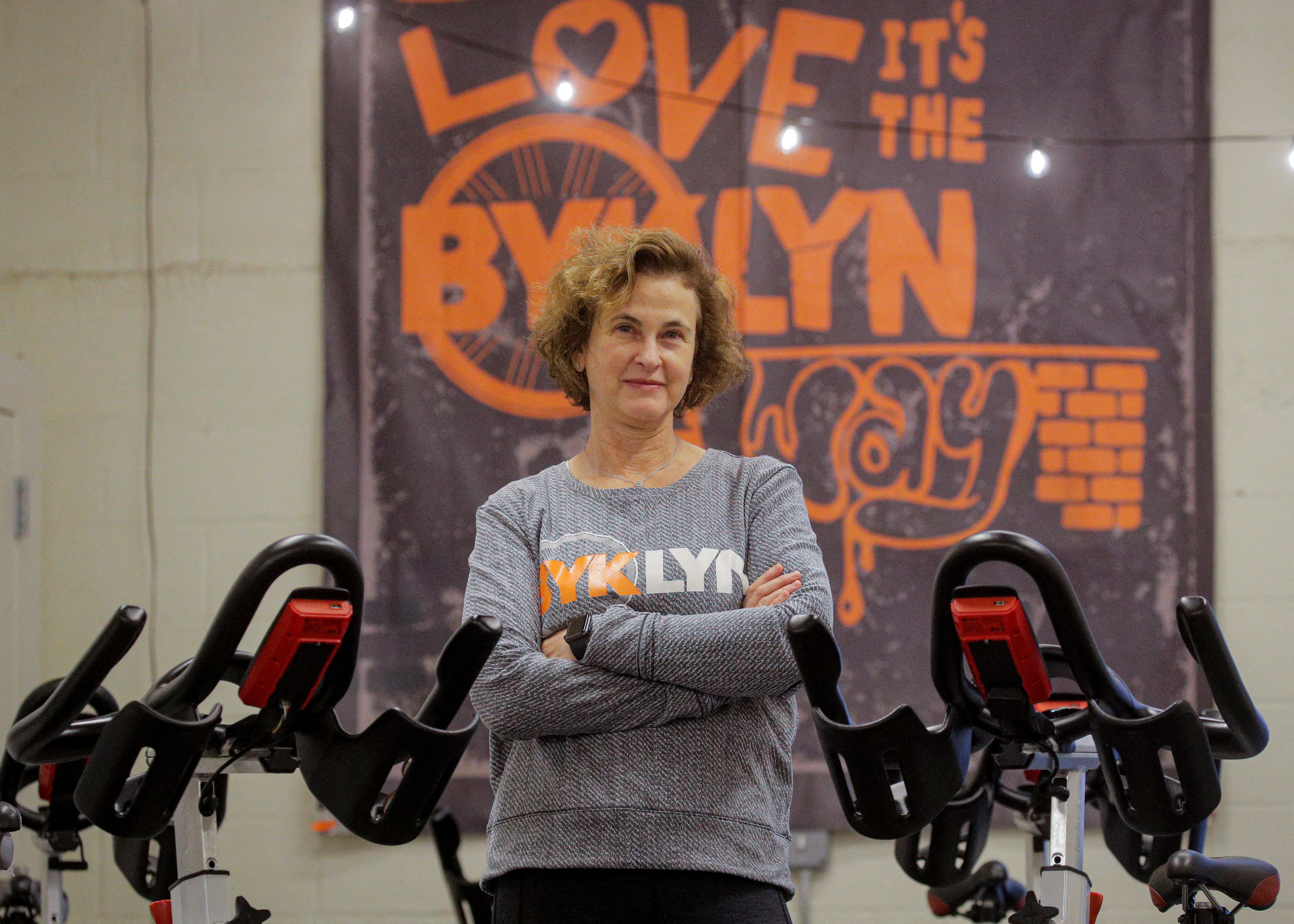 Amy Glosser poses in her cycling studio, BYKlyn, in Brooklyn, New York