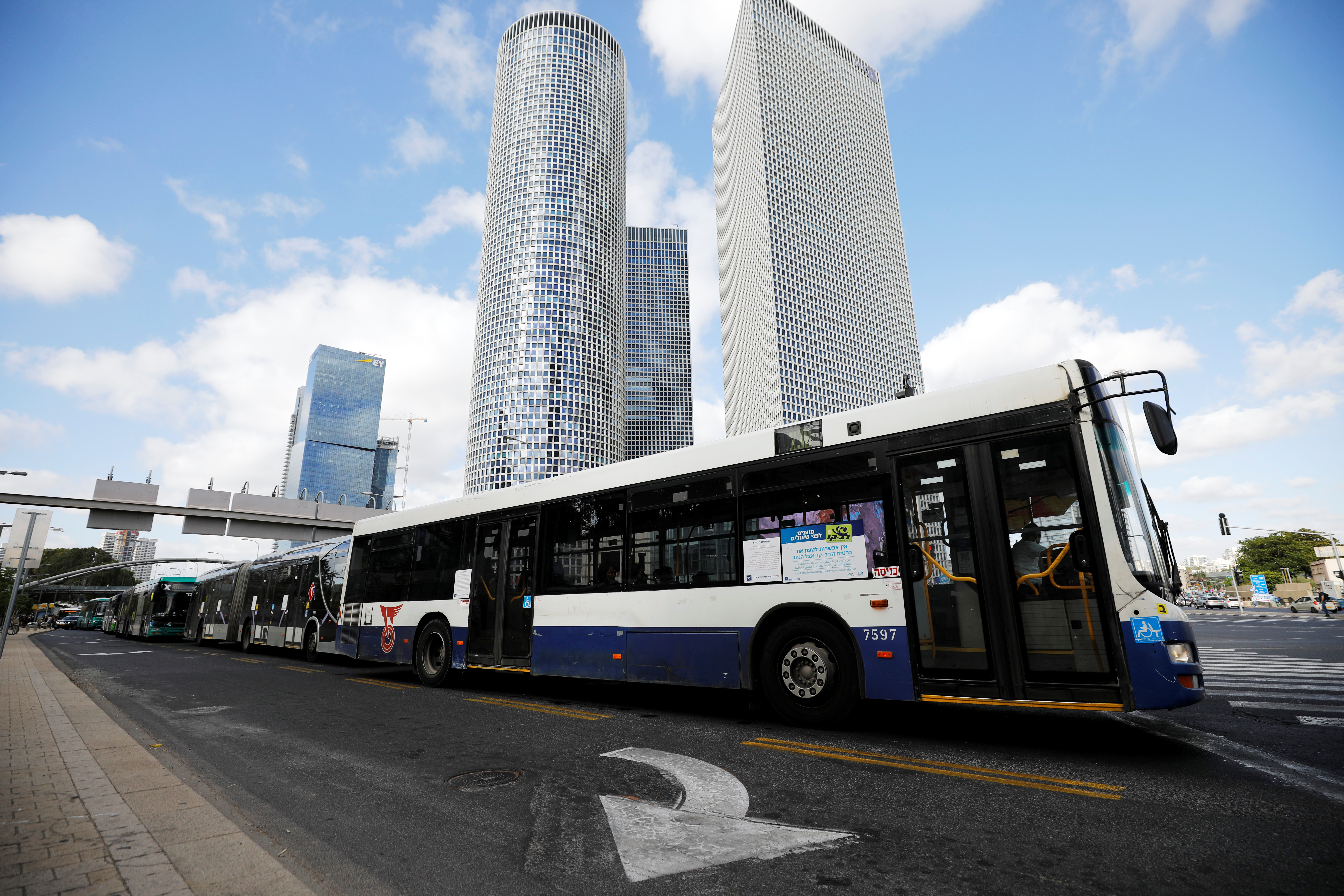 Buses travel past Azrieli Center in Tel Aviv, Israel