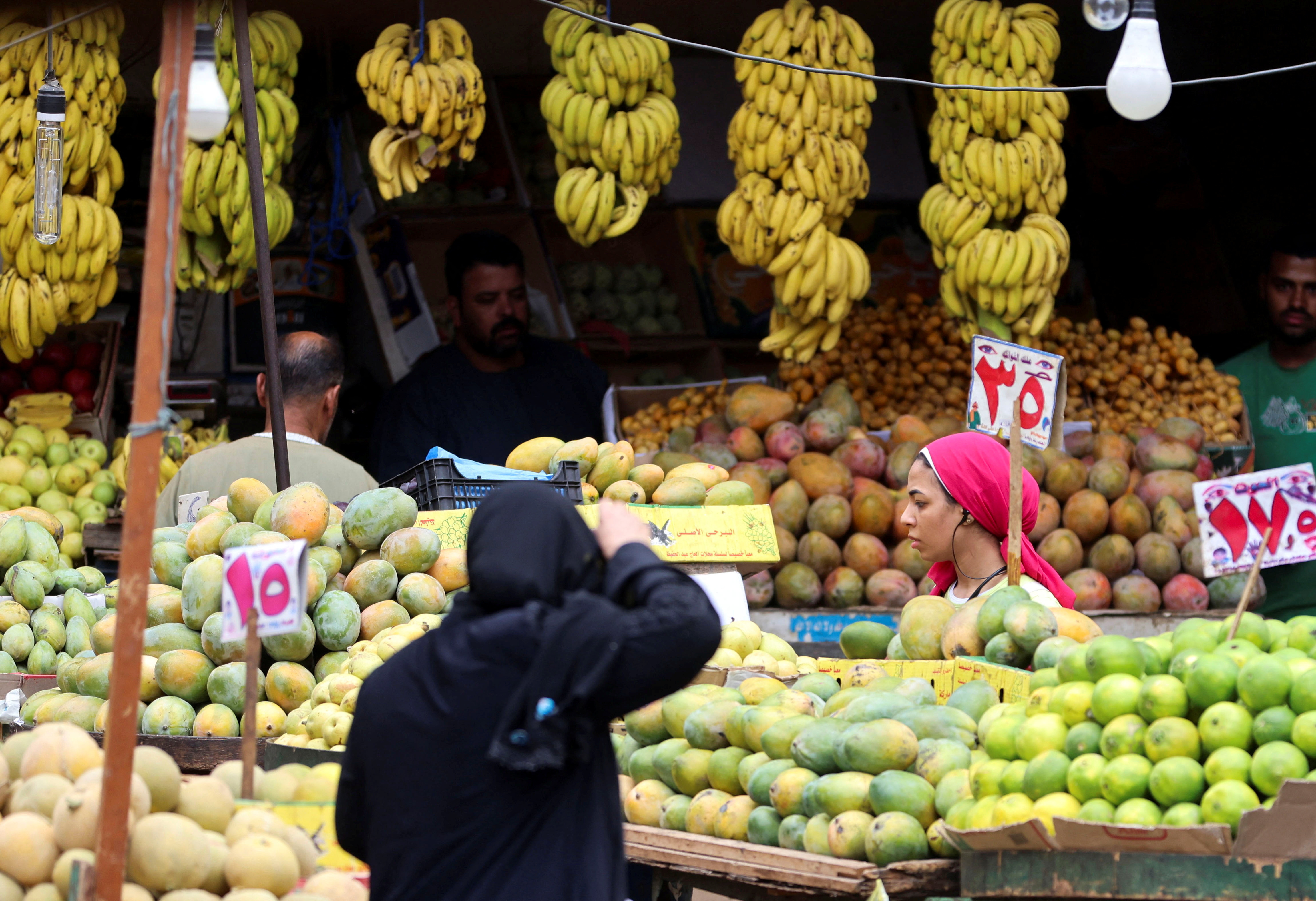 A woman shops at a vegetable and fruits market in Cairo