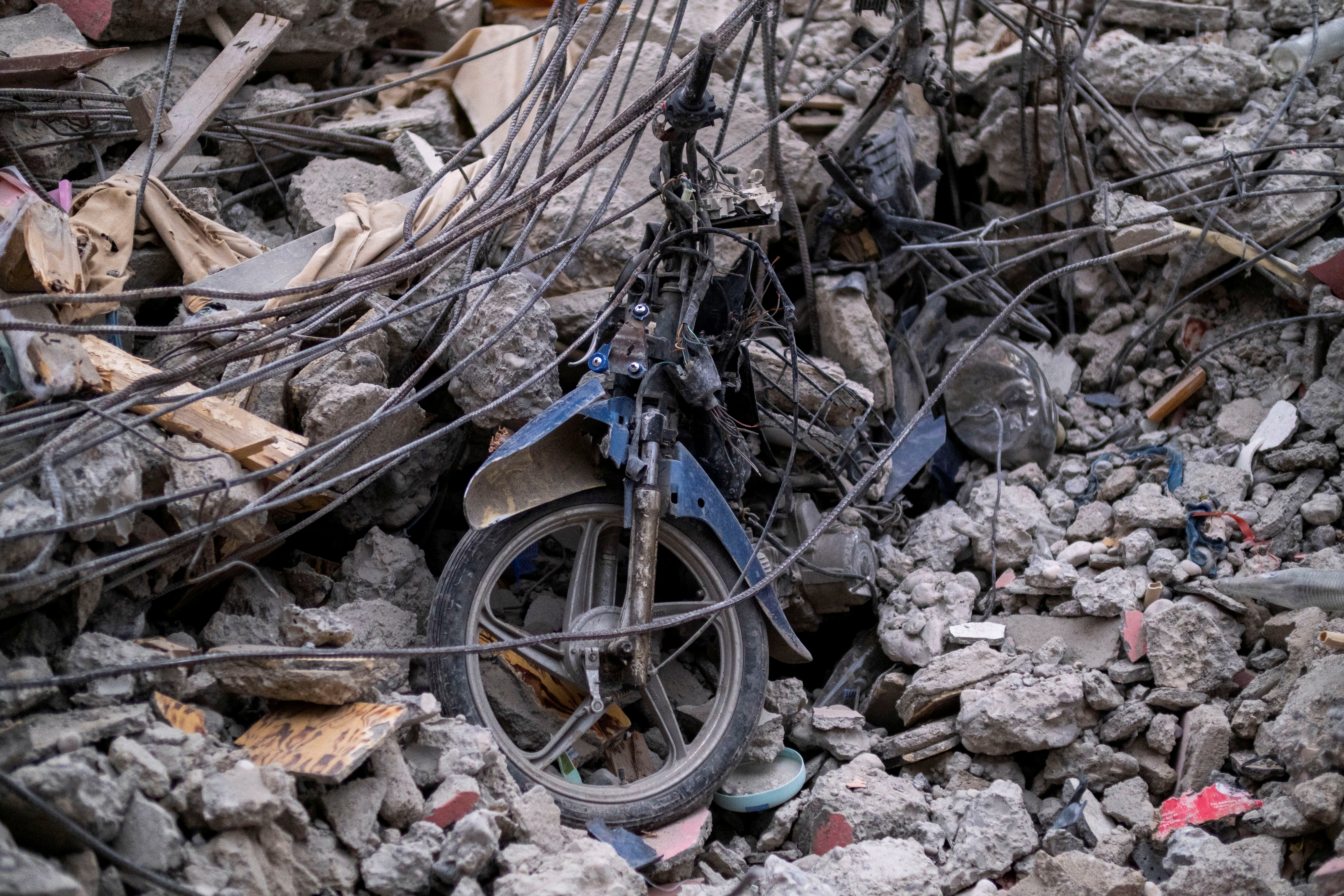 Parts of a motorcycle are seen in the rubble of a destroyed hotel after Saturday's 7.2 magnitude quake, in Les Cayes, Haiti August 16, 2021. REUTERS/Ricardo Arduengo
