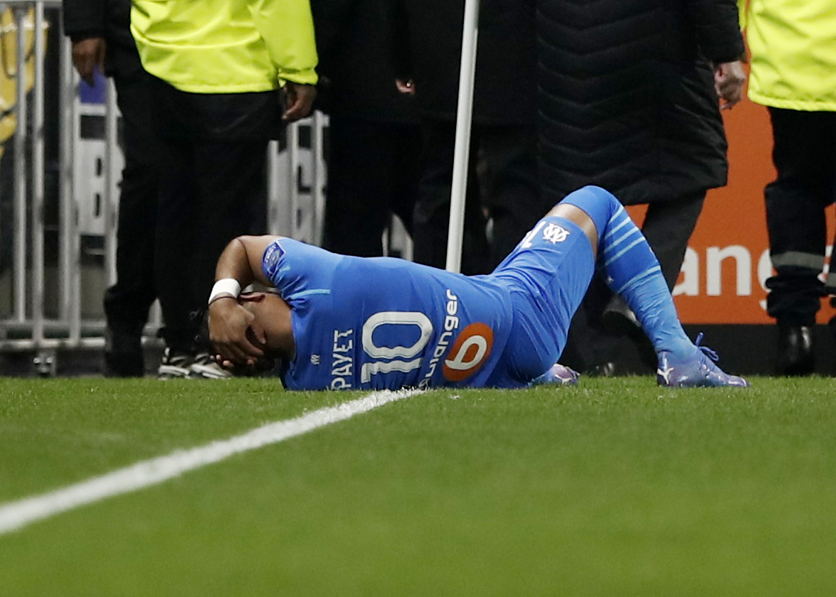 Soccer Football - Ligue 1 - Olympique Lyonnais v Olympique de Marseille - Groupama Stadium, Lyon, France - November 21, 2021  Olympique de Marseille's Dimitri Payet goes down after being hit by a water bottle thrown by a fan leading to the game being interrupted REUTERS/Benoit Tessier