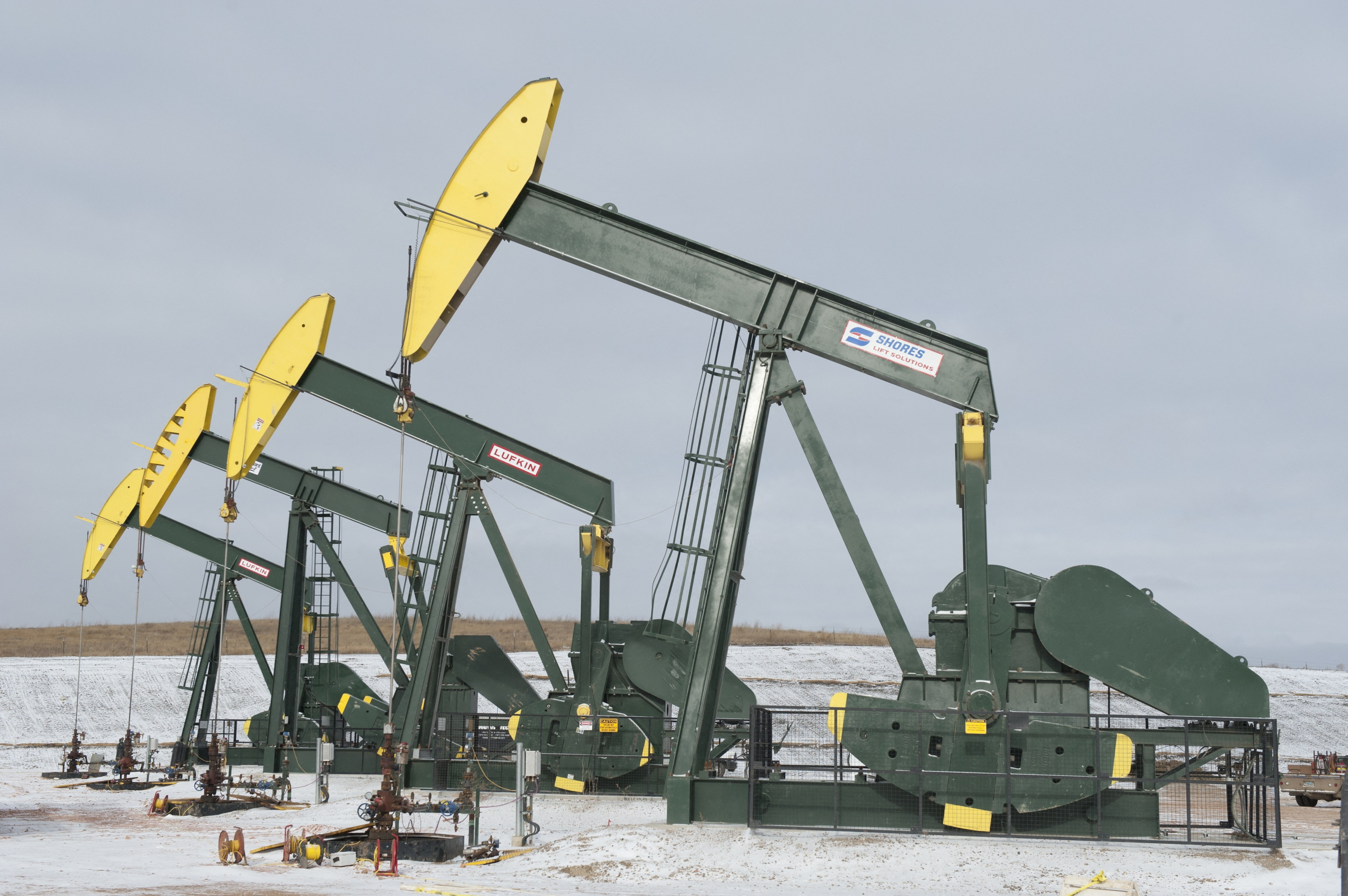 Pumpjacks taken out of production temporarily stand idle at a Hess site while new wells are fracked near Williston