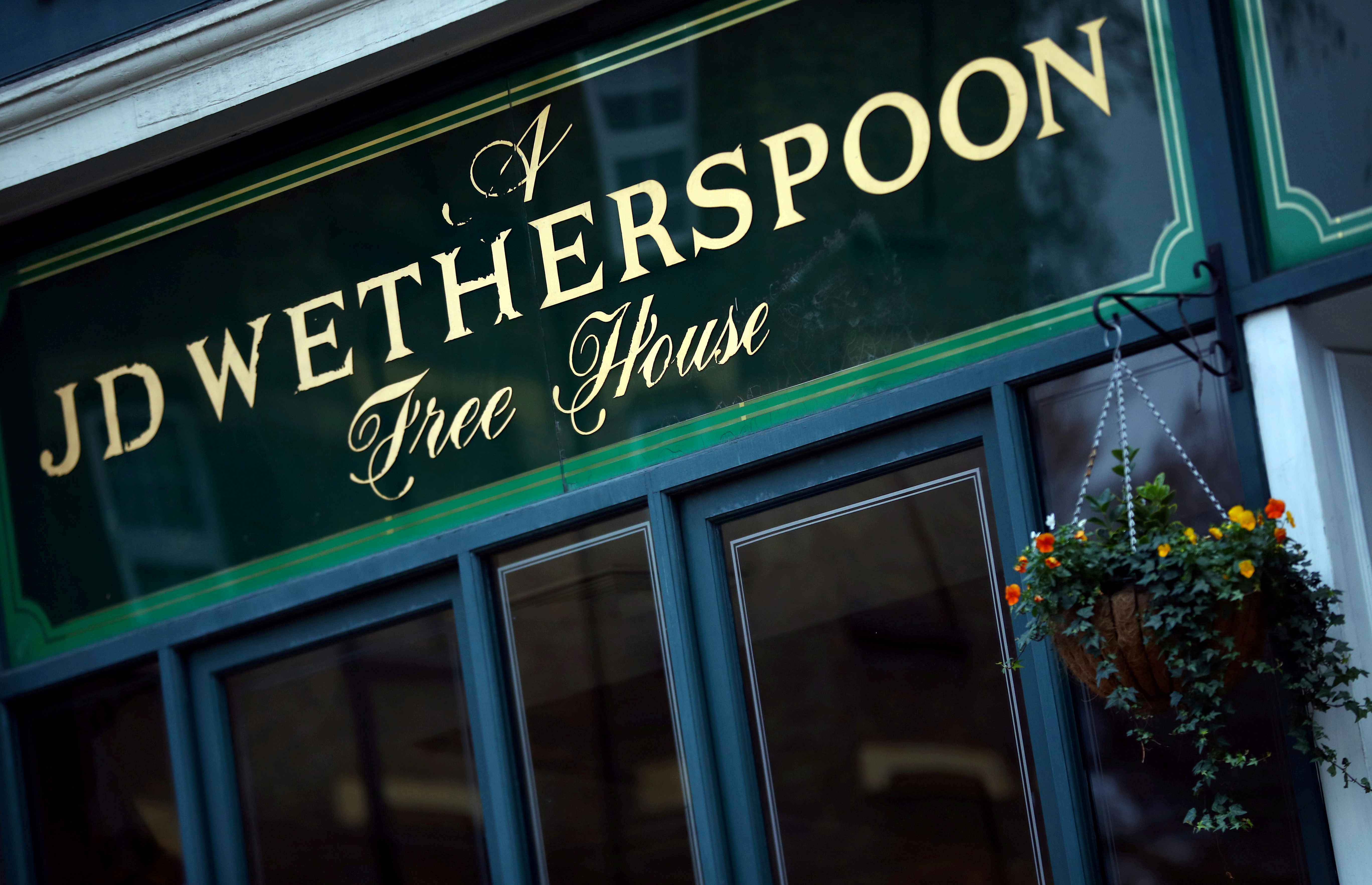 FILE PHOTO: A Wetherspoon's logo is seen at a pub in central London