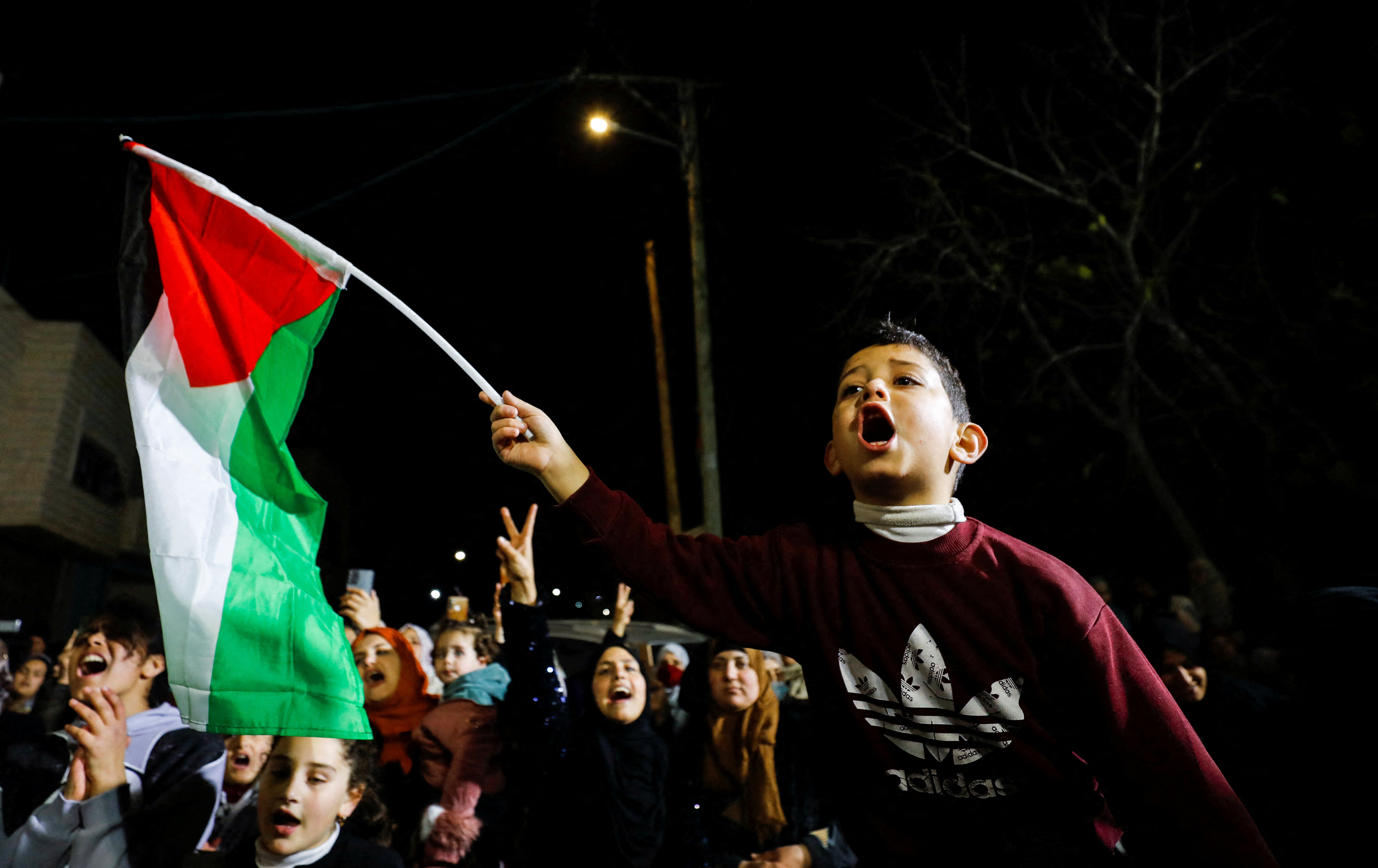 Relatives of Palestinian prisoner Hisham Abu Hawash celebrate in Dura, West Bank