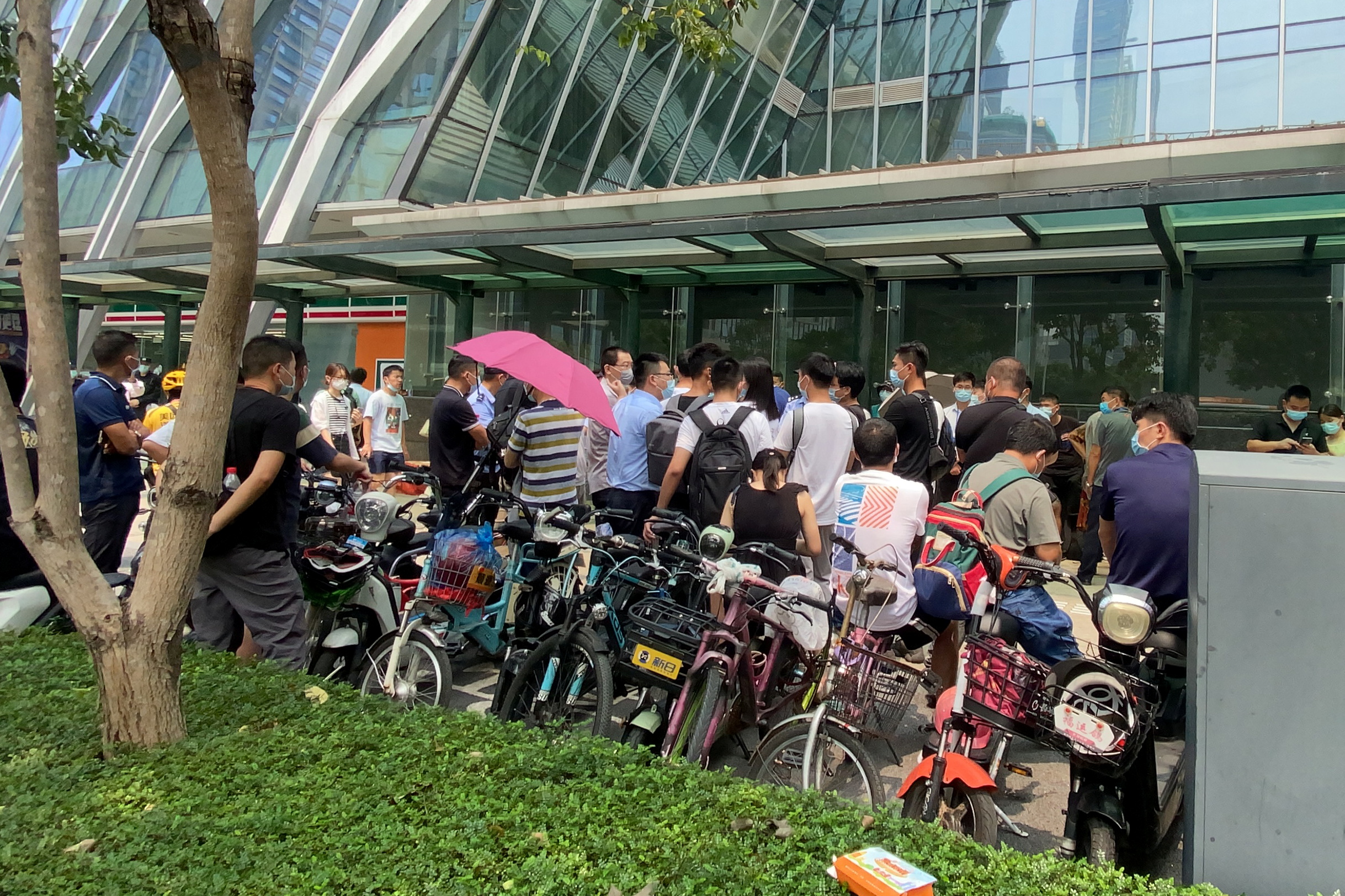 People protest to demand repayment of loans and financial products at the Evergrande's headquarters in Shenzhen