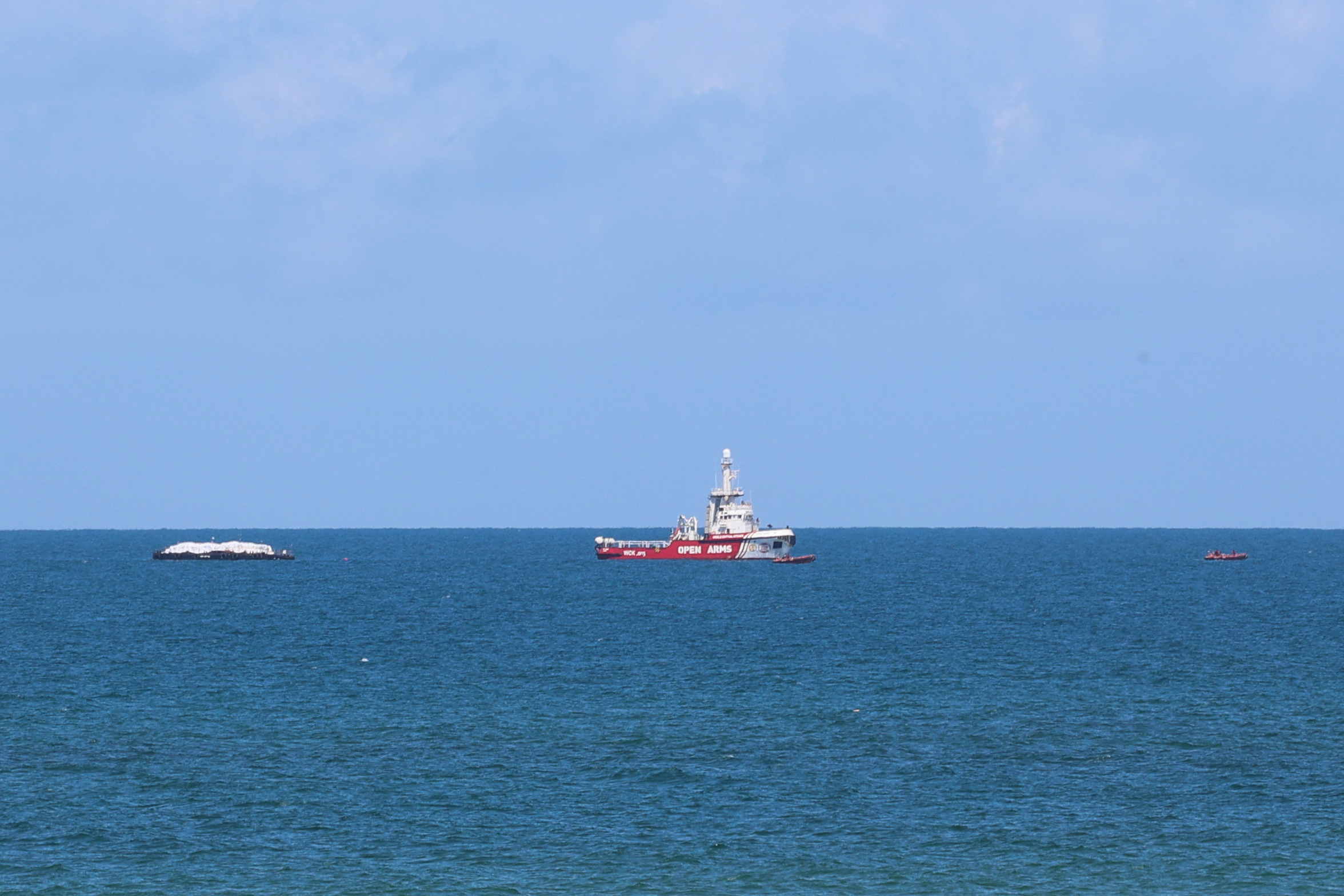 A ship carrying aid sails off the shore of Gaza, as seen from central Gaza Strip