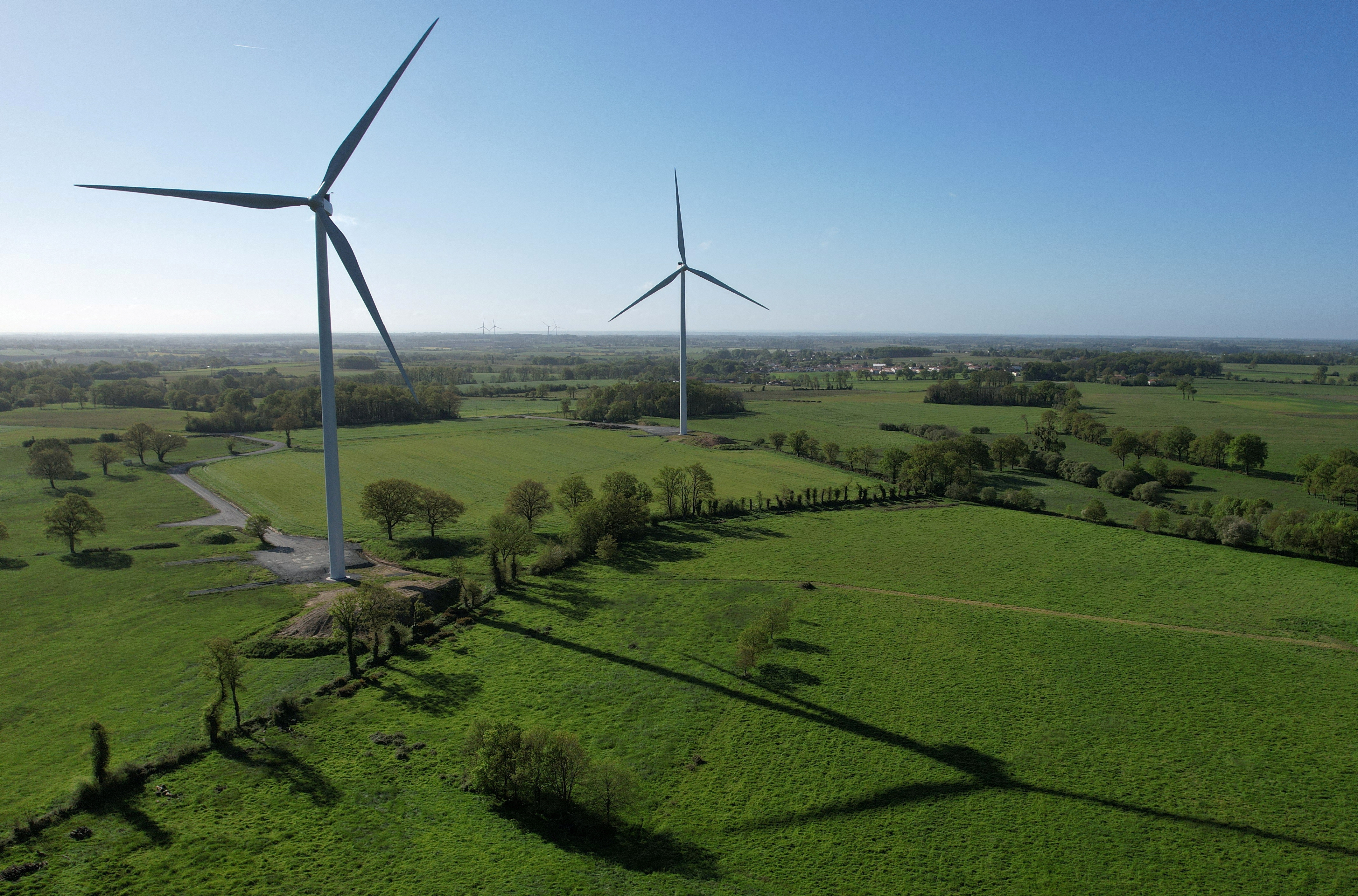 A drone view of power-generating windmill turbines in La Regrippiere