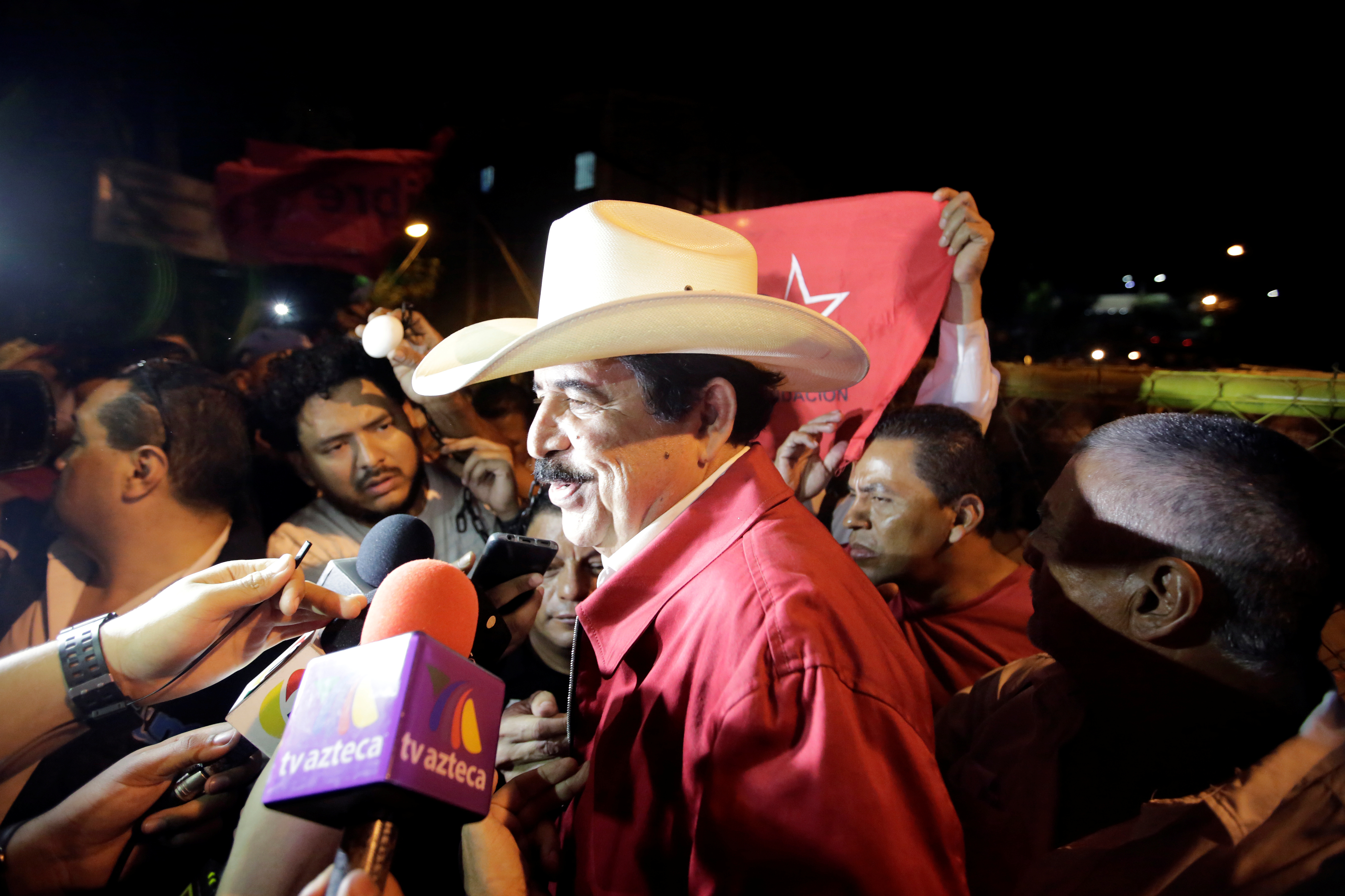 Honduras' former president Manuel Zelaya speaks to reporters during a protest to mark the first anniversary of a contested presidential election with allegations of electoral fraud, in Tegucigalpa
