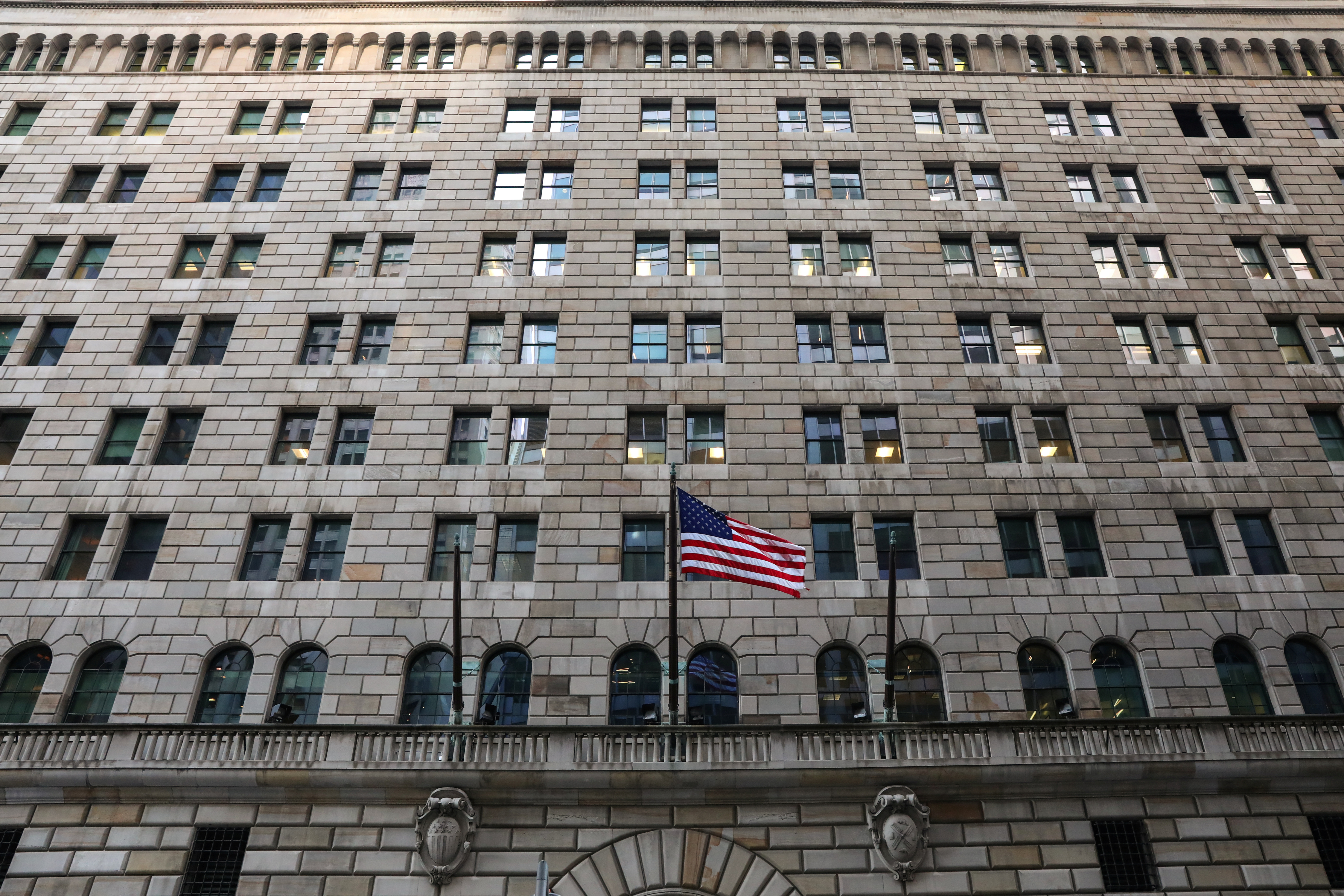 The U.S. flag flies on the Federal Reserve Bank of New York in the financial district in New York