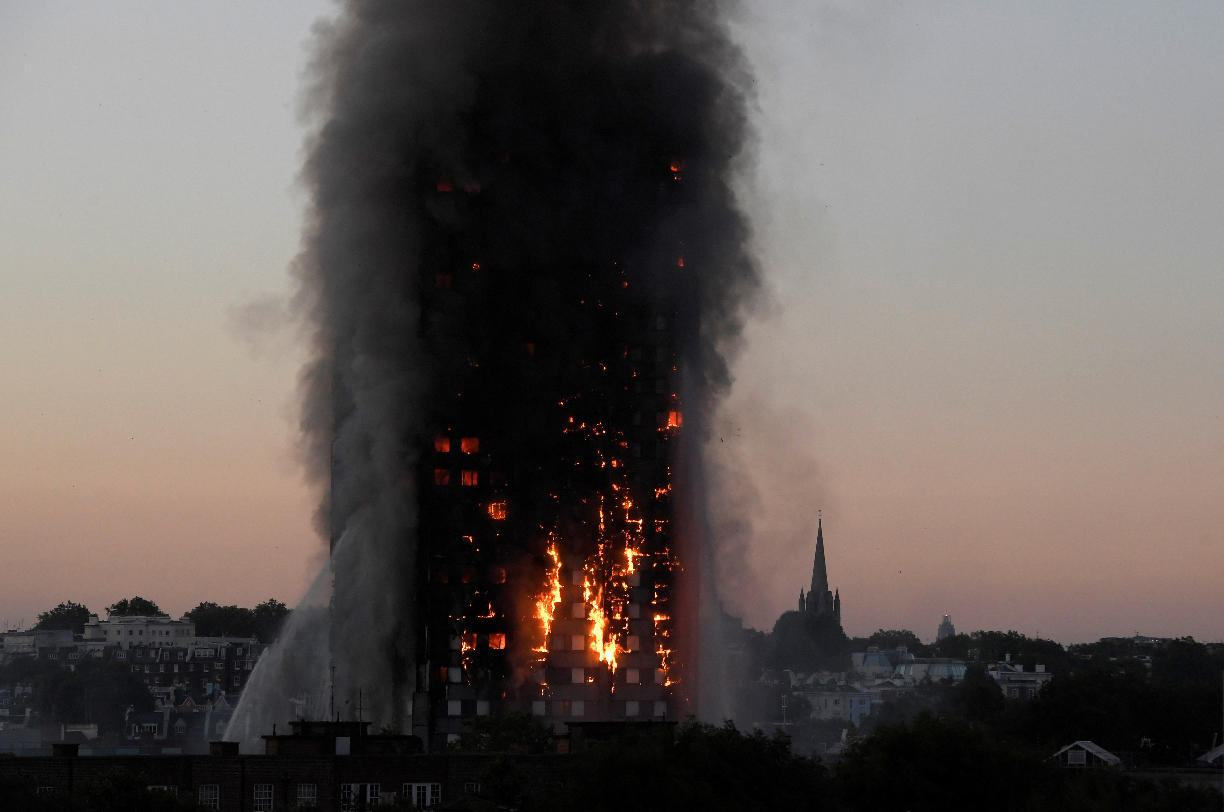 The Grenfell Tower residential building is seen on fire in London