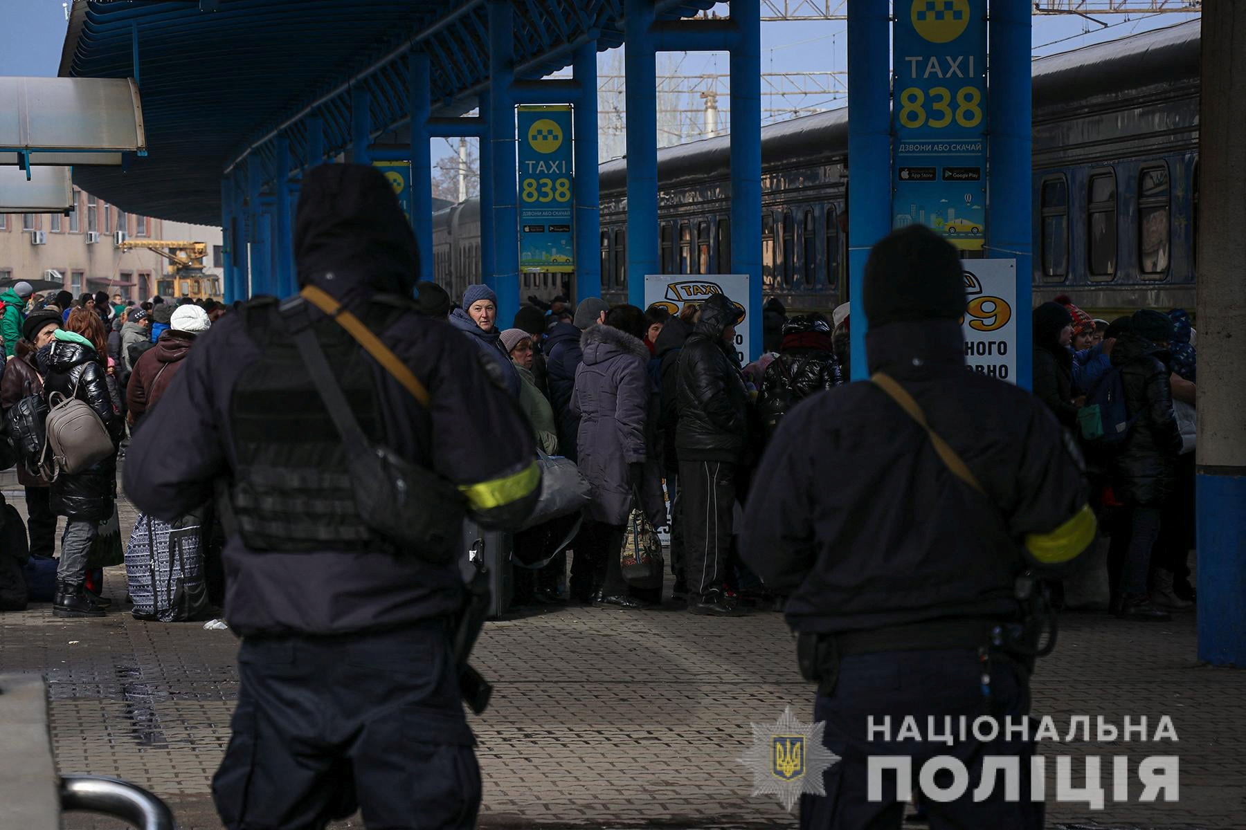 People fleeing from Mariupol stand at railway station in Zaporizhzhia