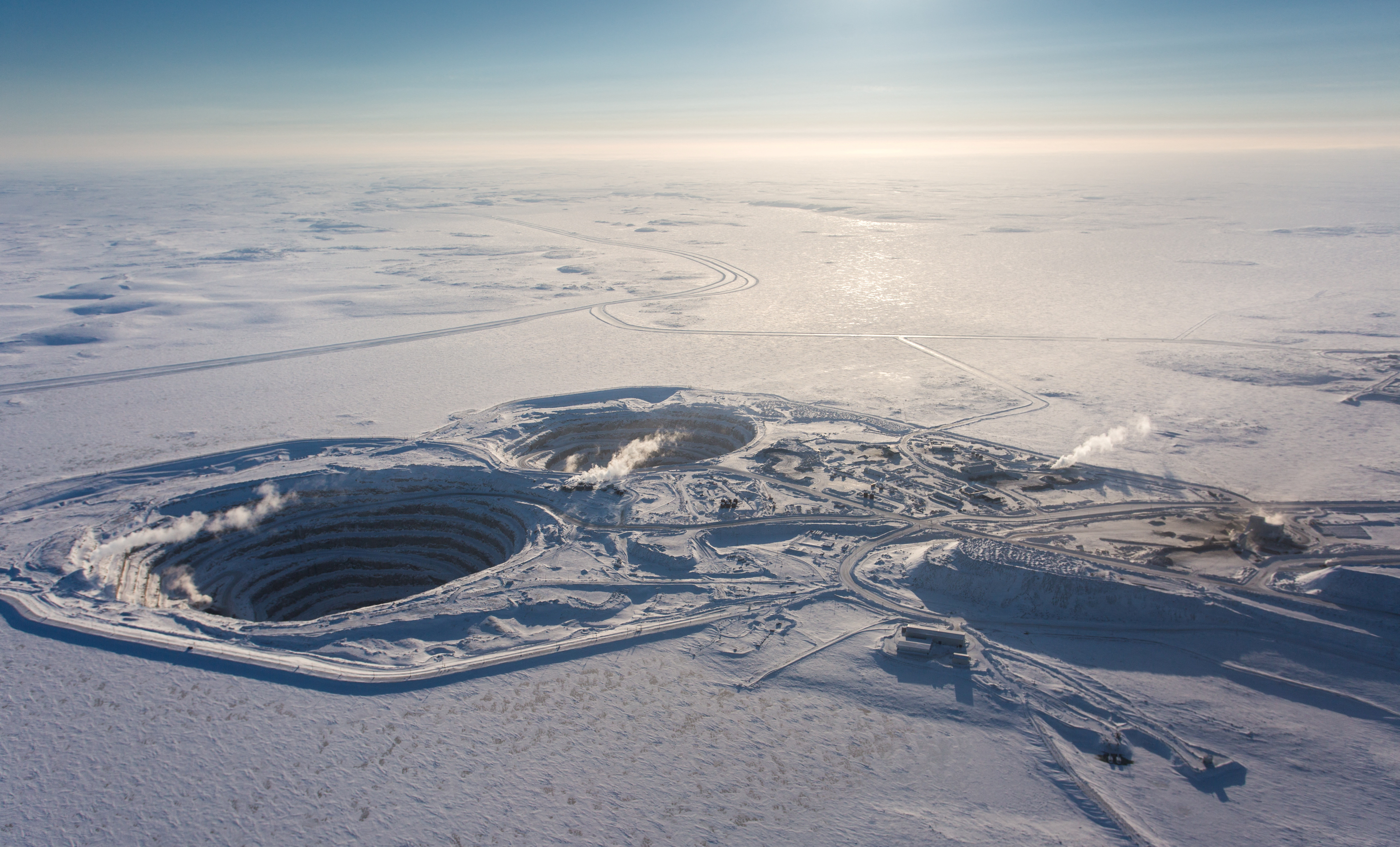 The winter road is seen in the background of an aerial photograph of Rio Tinto's Diavik Diamond Mine