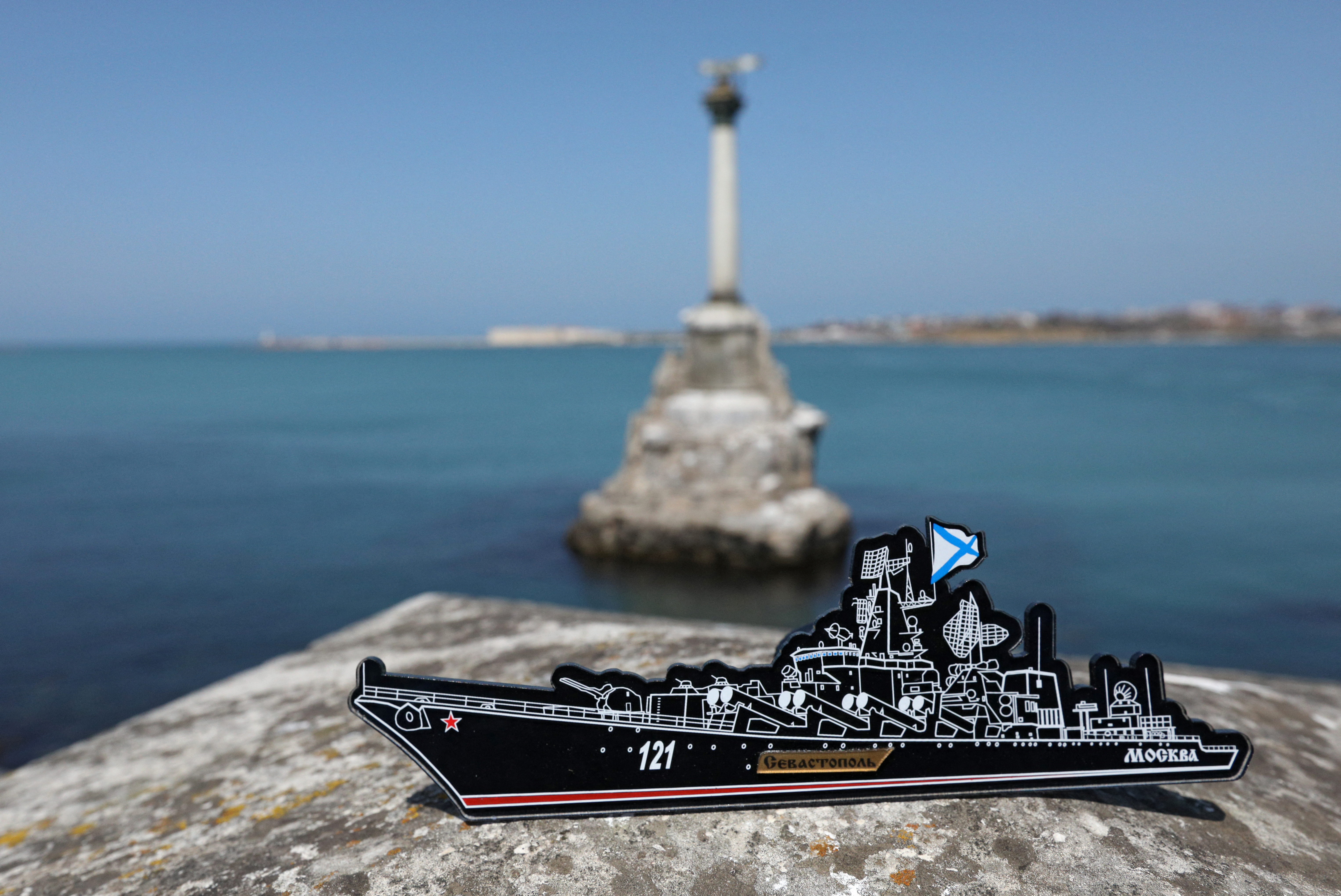 A magnet depicting the Russian missile cruiser Moskva, which sank in the Black Sea following a fire, is pictured at an embankment in Sevastopol