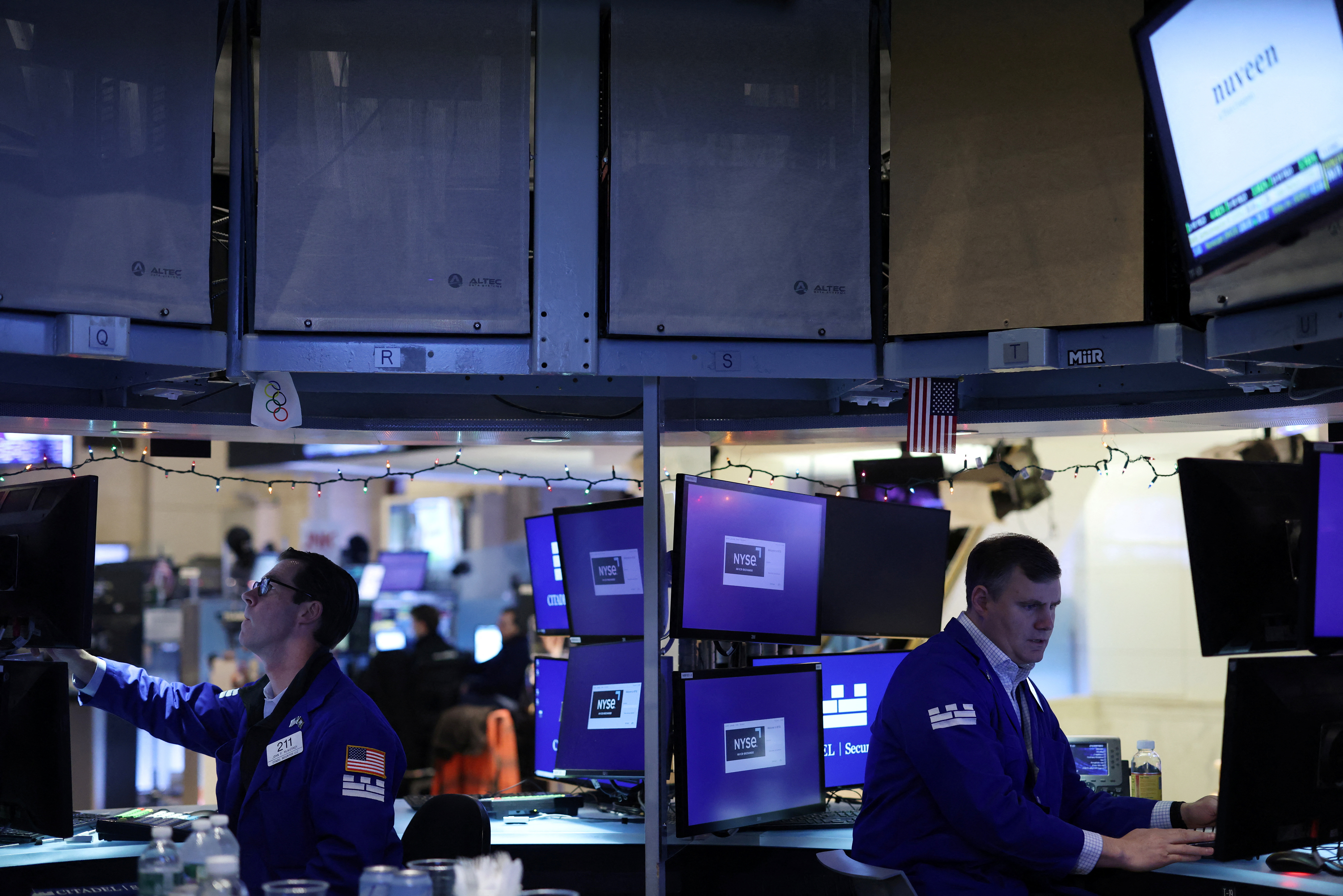 Traders work on the trading floor at the New York Stock Exchange (NYSE) in New York