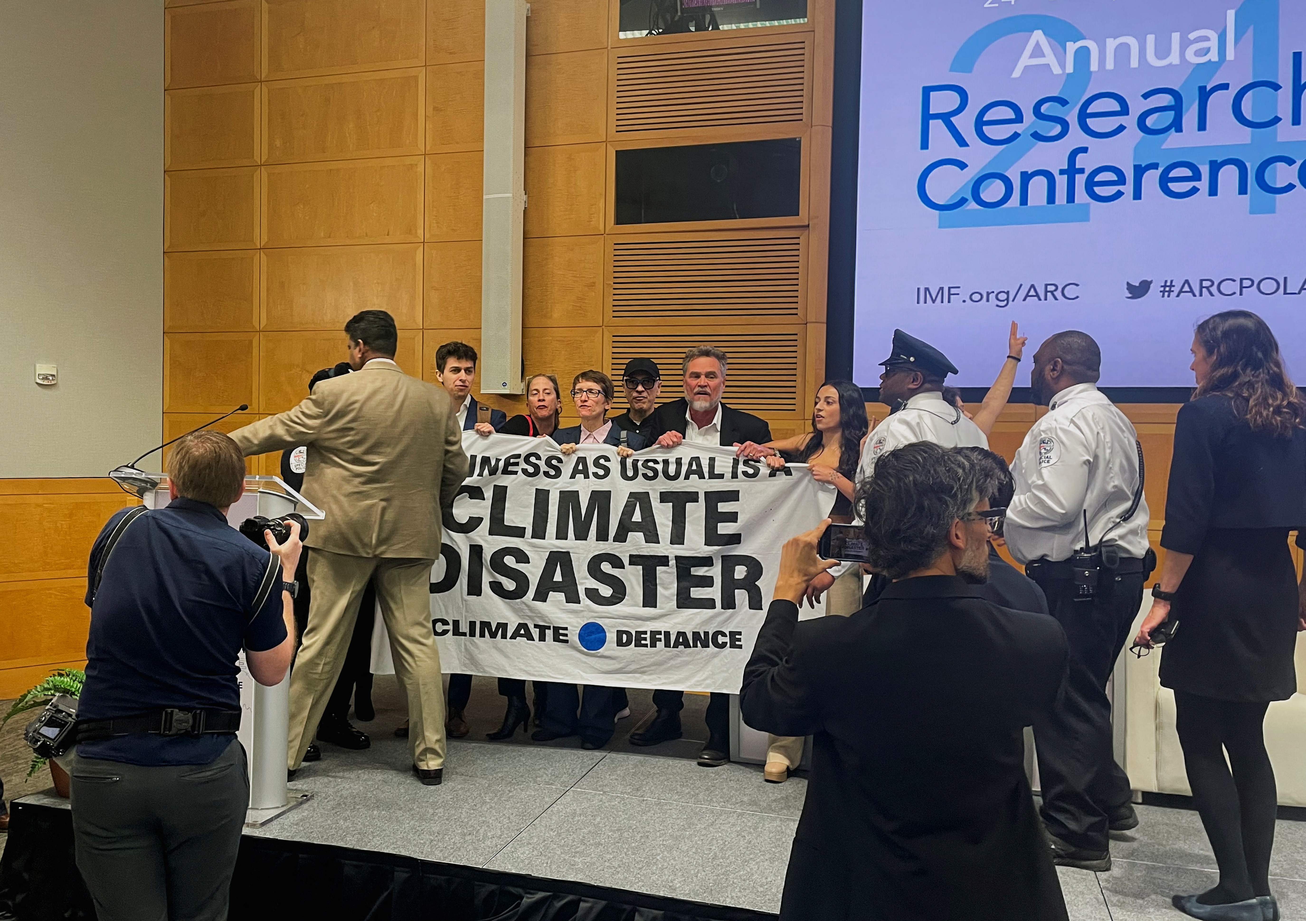 Climate protesters interrupt an event with Federal Reserve Chair Jerome Powell at the International Monetary Fund, in Washington