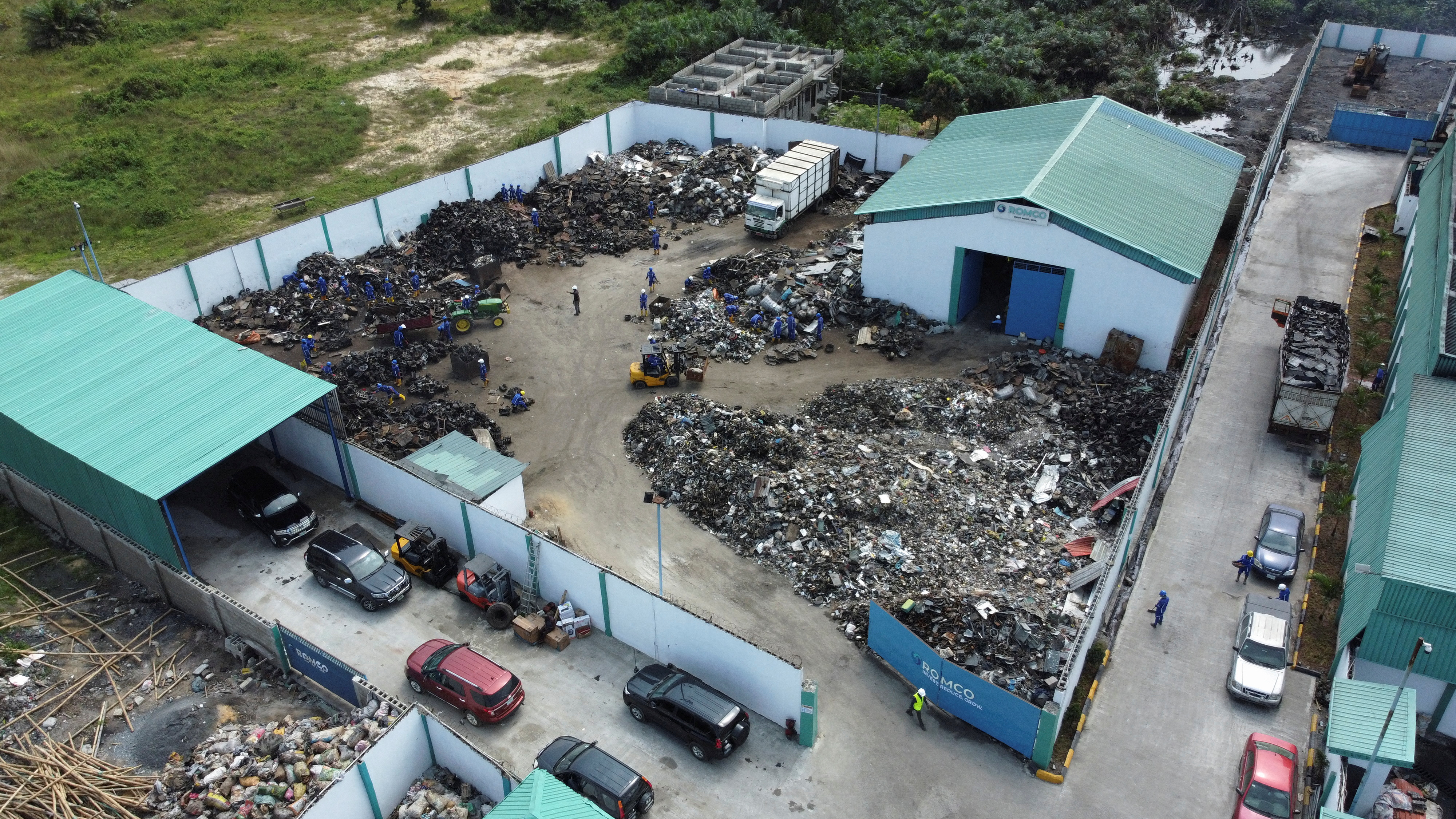 An aerial view shows workers sorting pieces of an aluminium engine at a Romco Recycling facility in Lagos