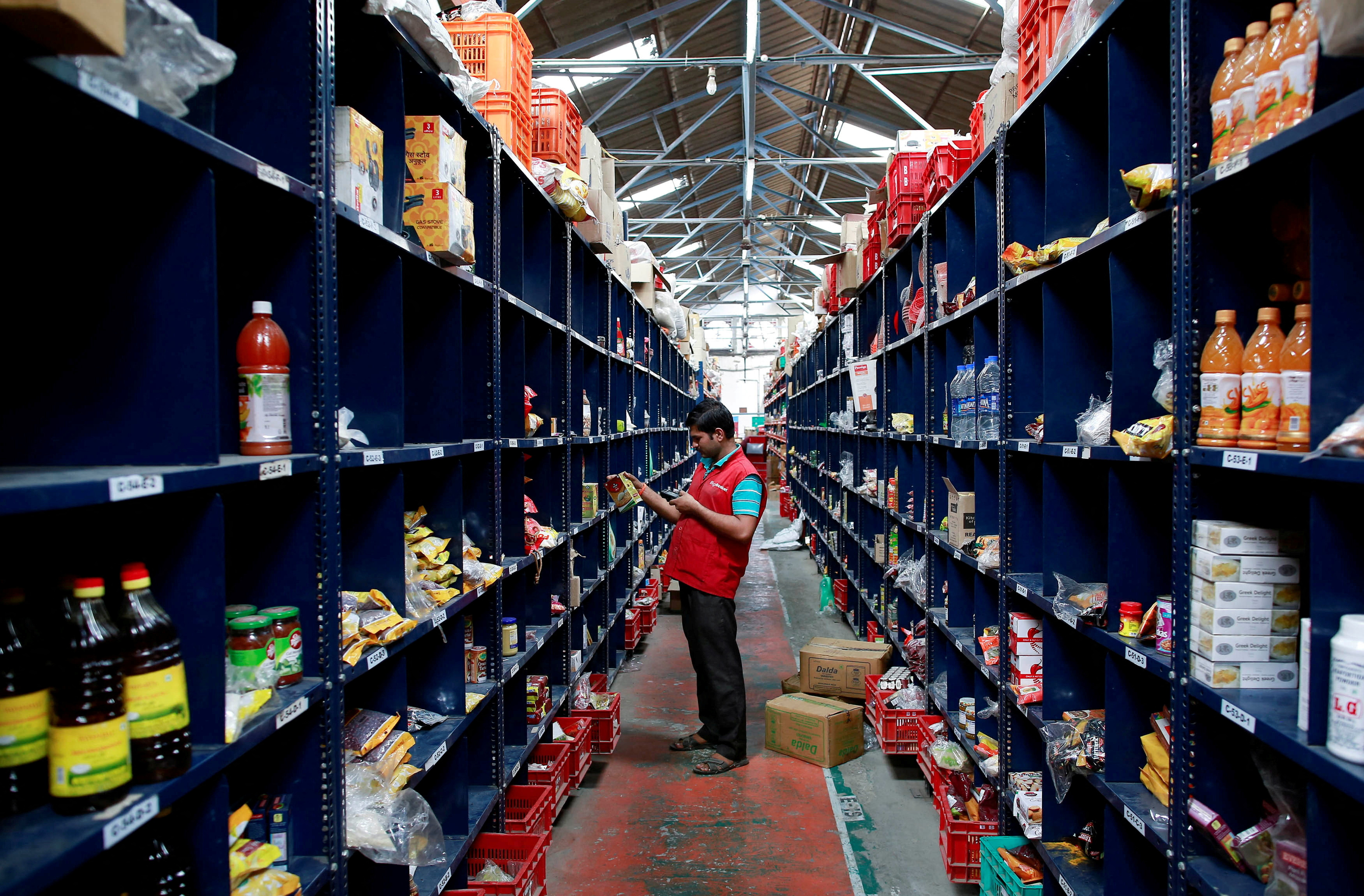 An employee scans a package for an order at a BigBasket warehouse on the outskirts of Mumbai