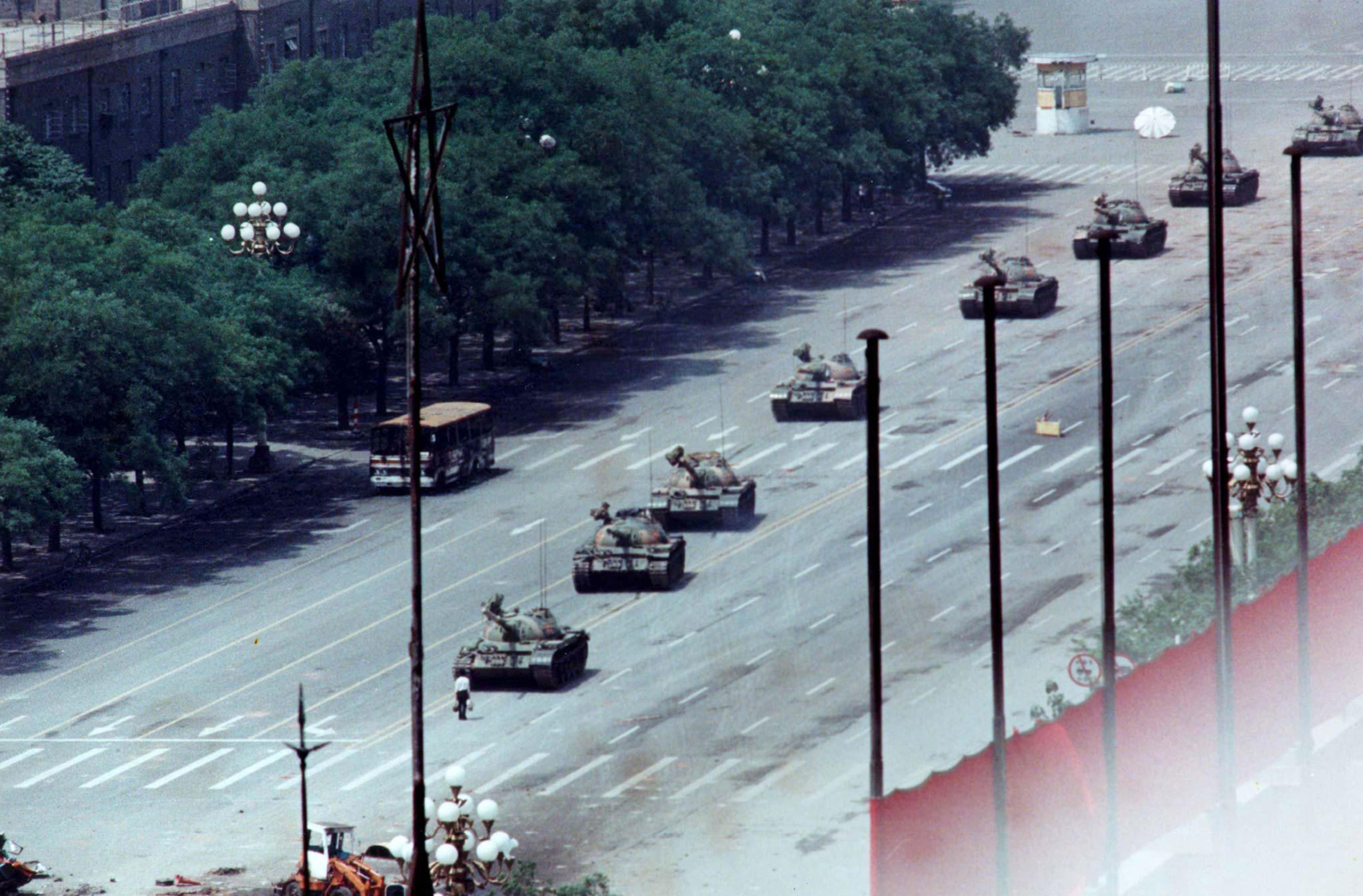 File photo shows a man standing passively to block a column of army tanks on Changan Avenue east of Tiananmen Square in Beijing