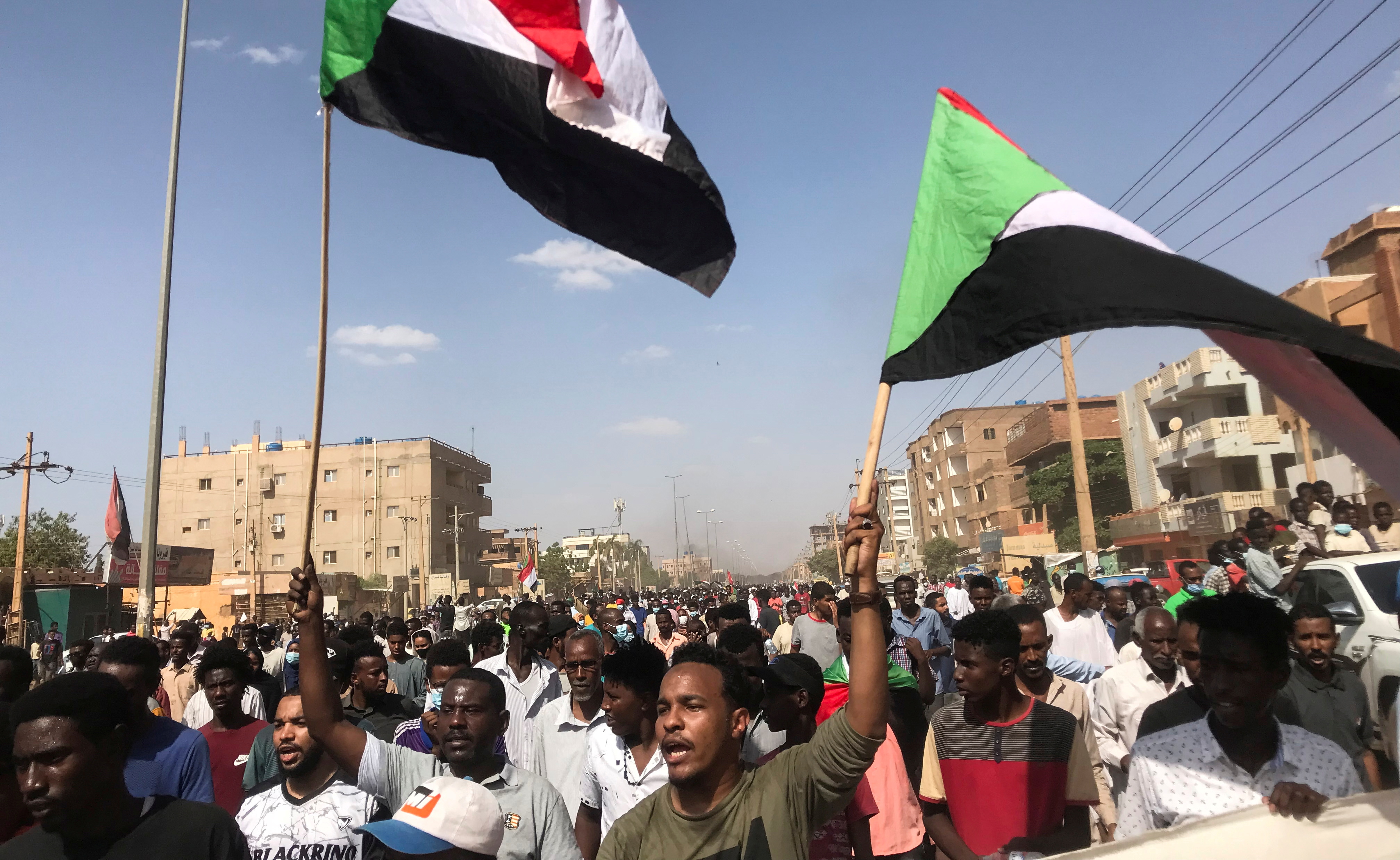 Protesters hold flags and chant slogans as they march against the Sudanese military's recent seizure of power and ousting of the civilian government, in the streets of the capital Khartoum, Sudan October 30, 2021. REUTERS/Mohamed Nureldin/File Photo