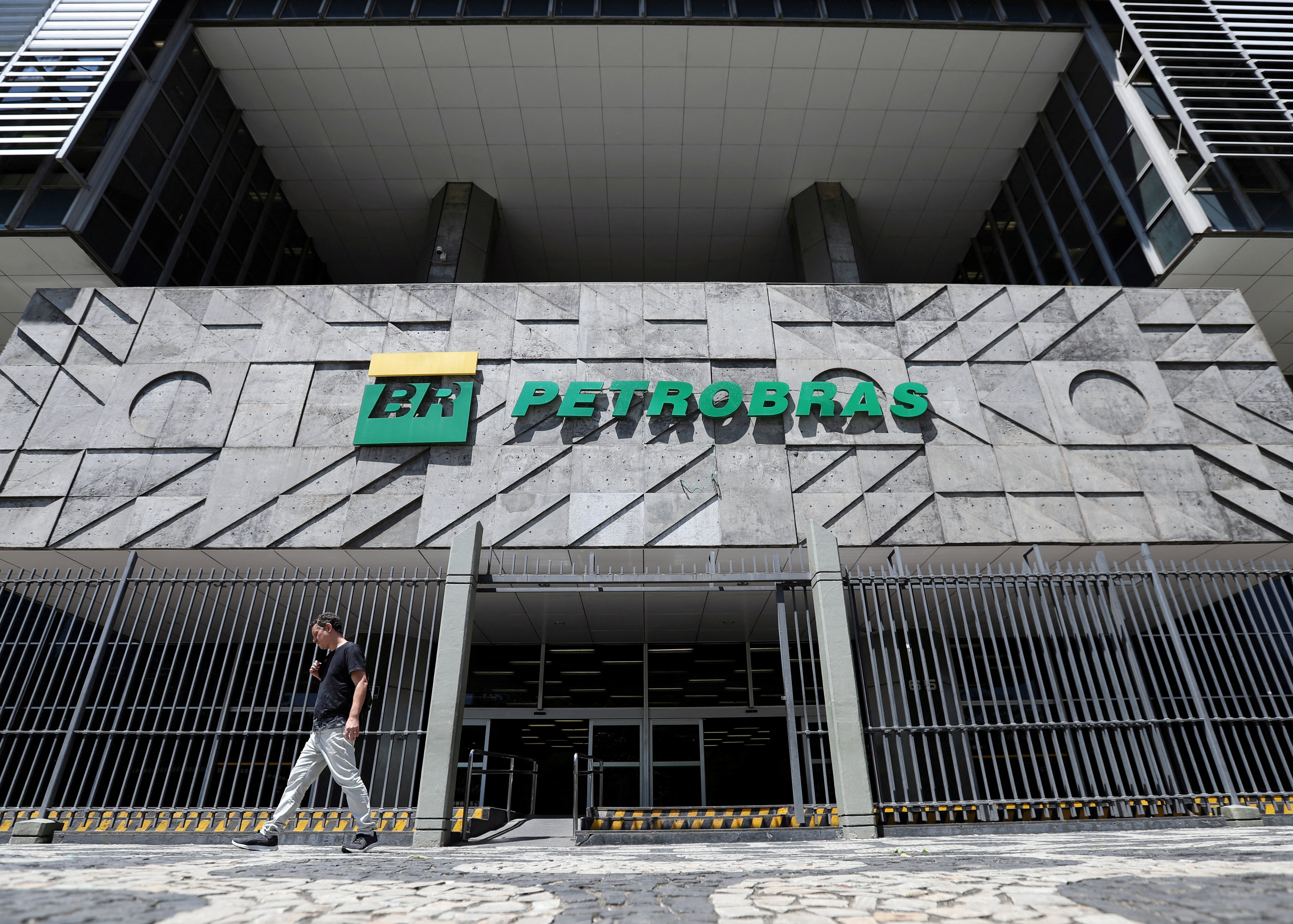 A man walks in front of the headquarters of Petroleo Brasileiro S.A. (Petrobas) in Rio de Janeiro