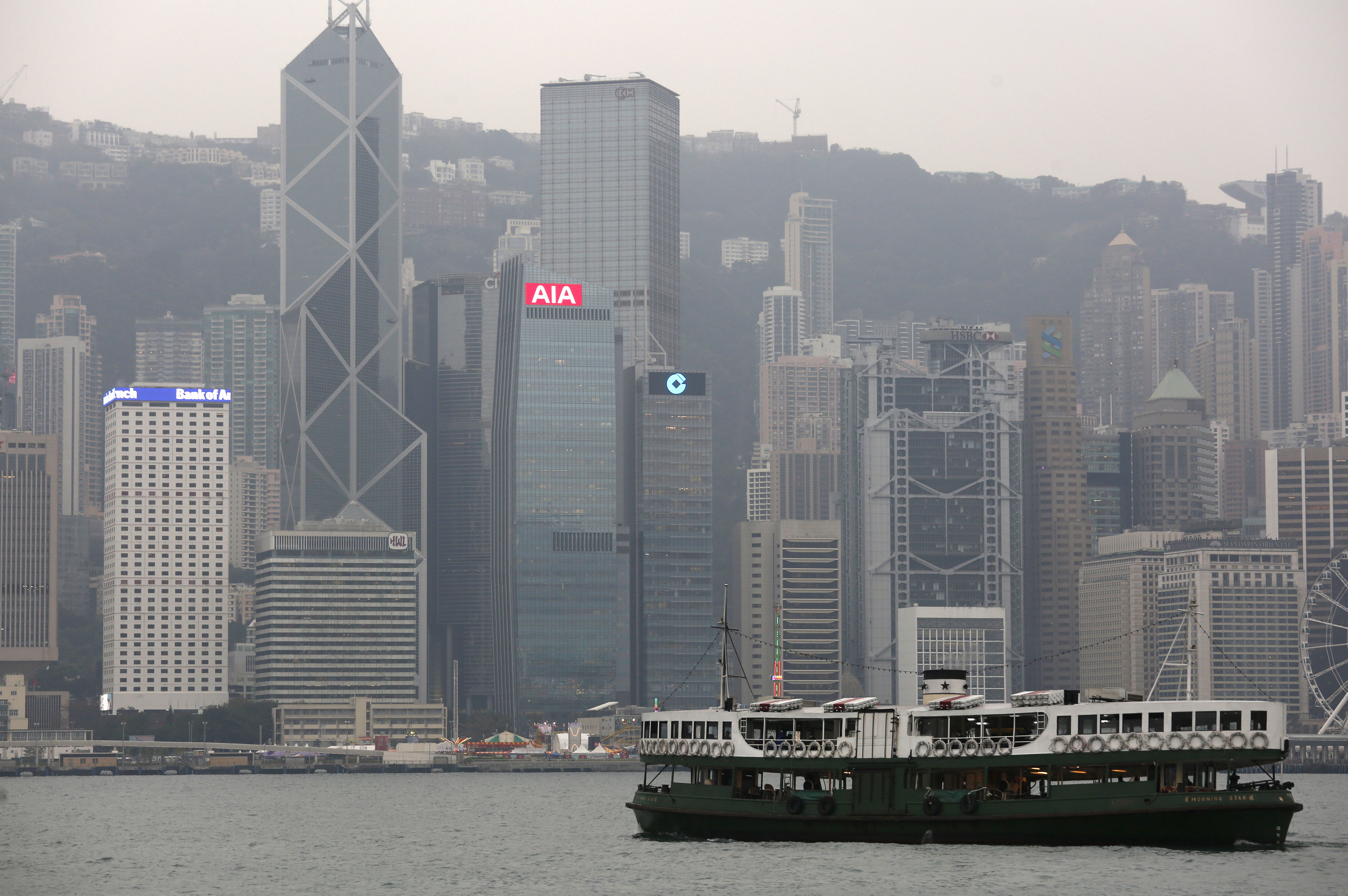 A ferry sails at Victoria Harbour in front of the financial Central district in Hong Kong