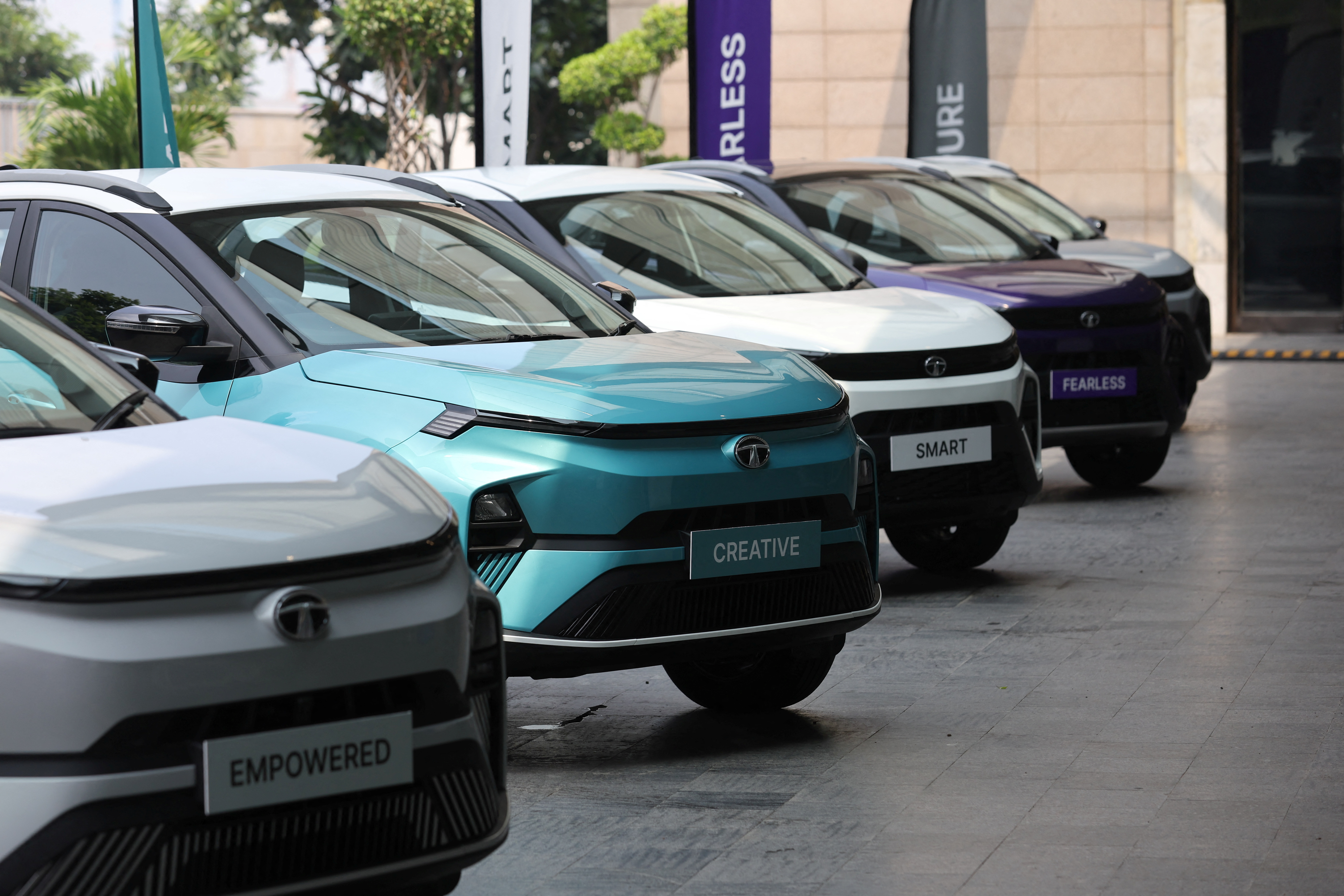 Tata Motors' Nexon and the electric vehicle Nexon.ev are seen parked for display outside a hotel ahead of its launch in New Delhi