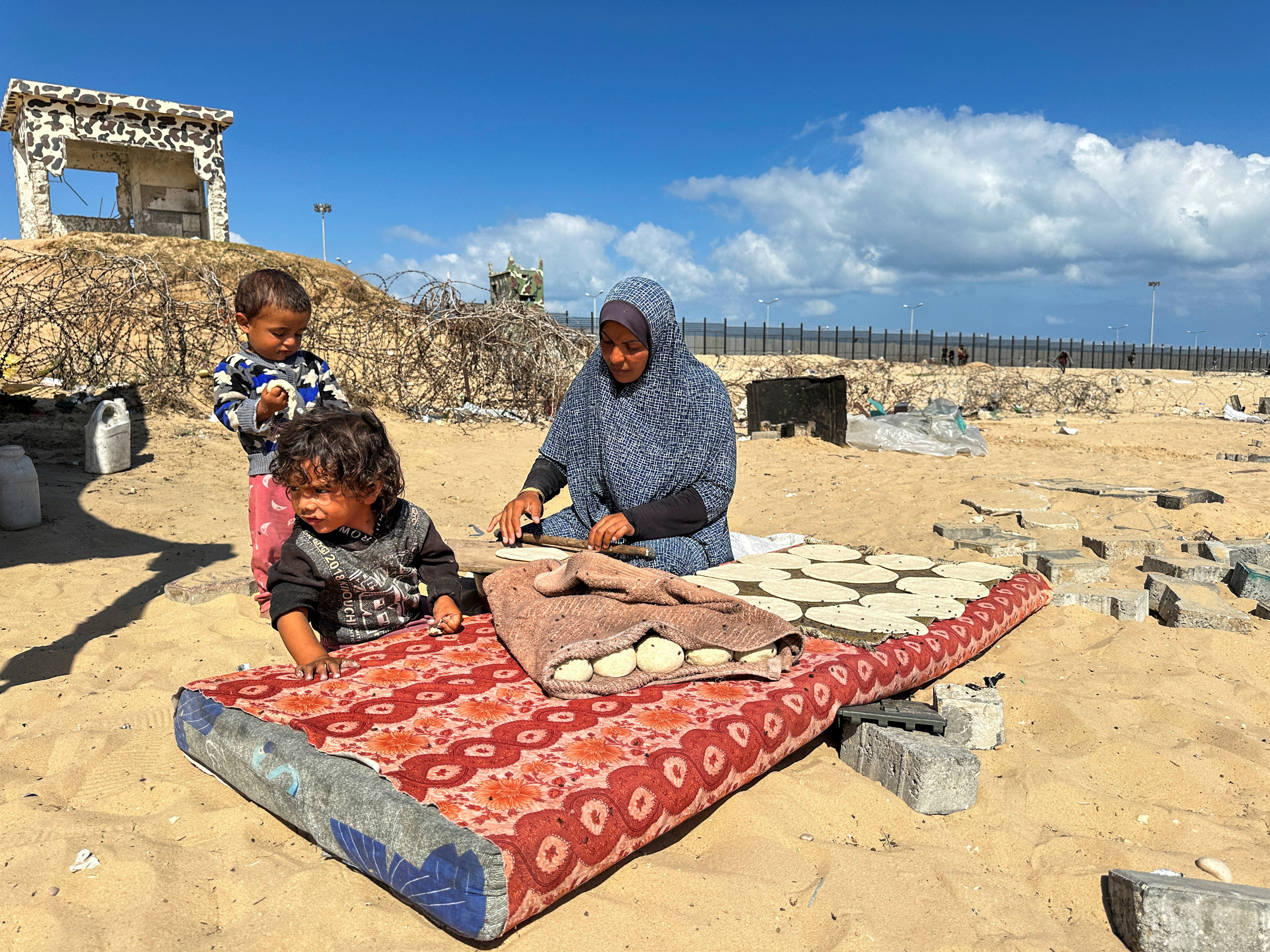 Displaced Palestinians take shelter at the border with Egypt, during an Israeli military operation, in Rafah