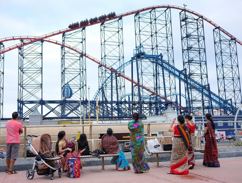 People watch the 'Big One' rollercoaster as they stand on the promenade following the outbreak of the coronavirus disease (COVID-19) in Blackpool