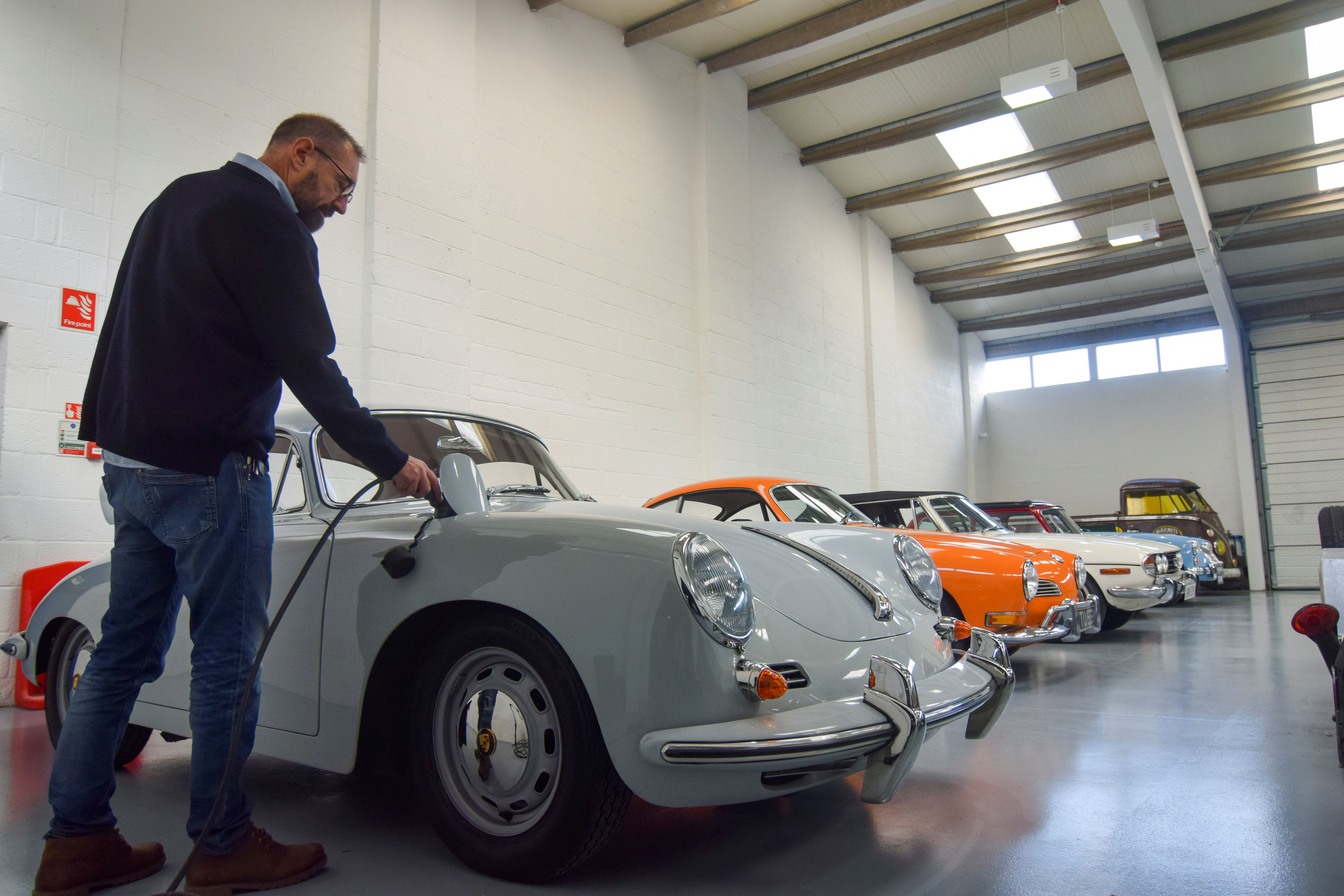Steve Drummond, co-founder of Electrogenic plugs a converted Porsche into a charger, in Kidlington