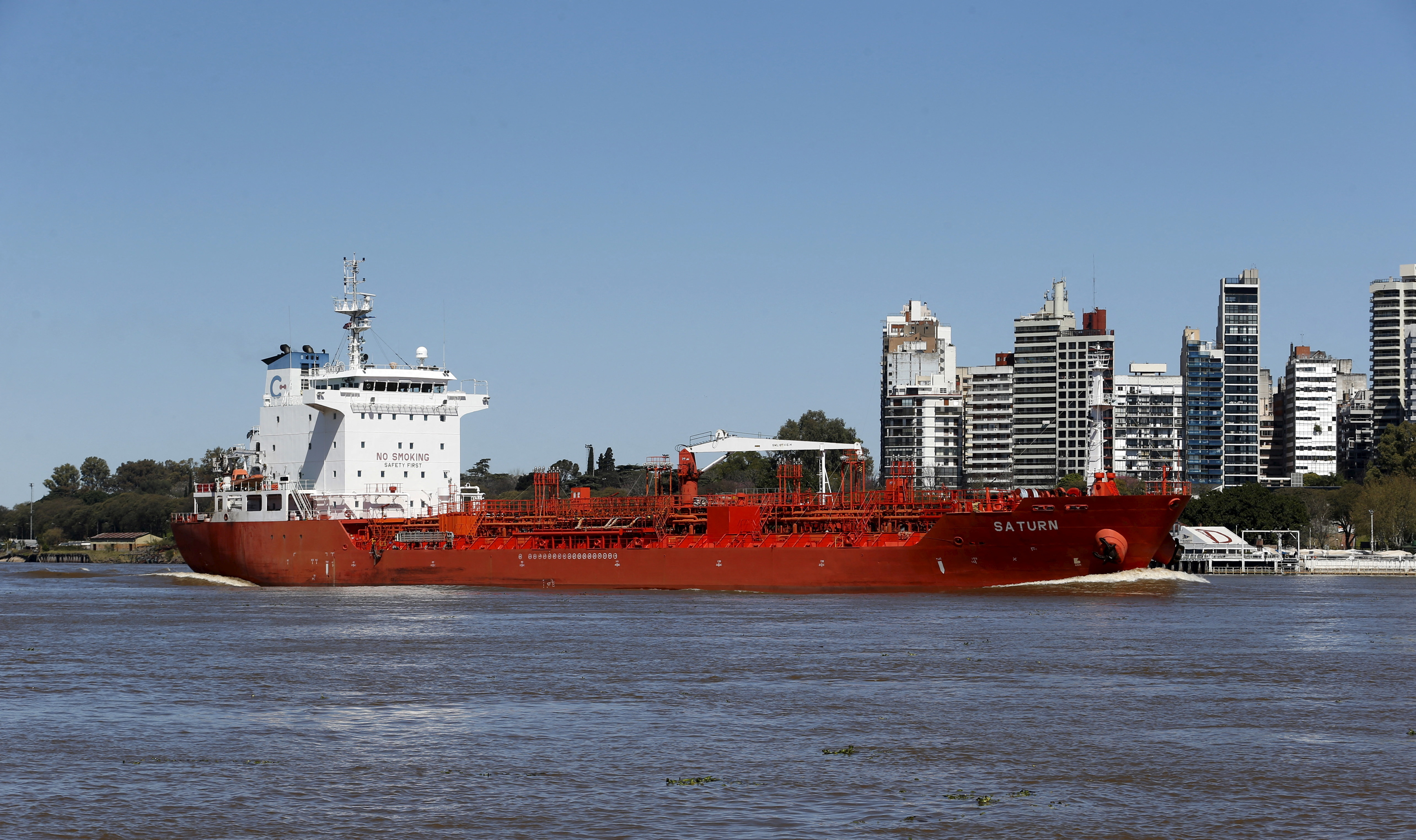 Oil tanker Saturn sailing under the Marshall Islands flag is seen by the Parana River, in front of the Rosario port