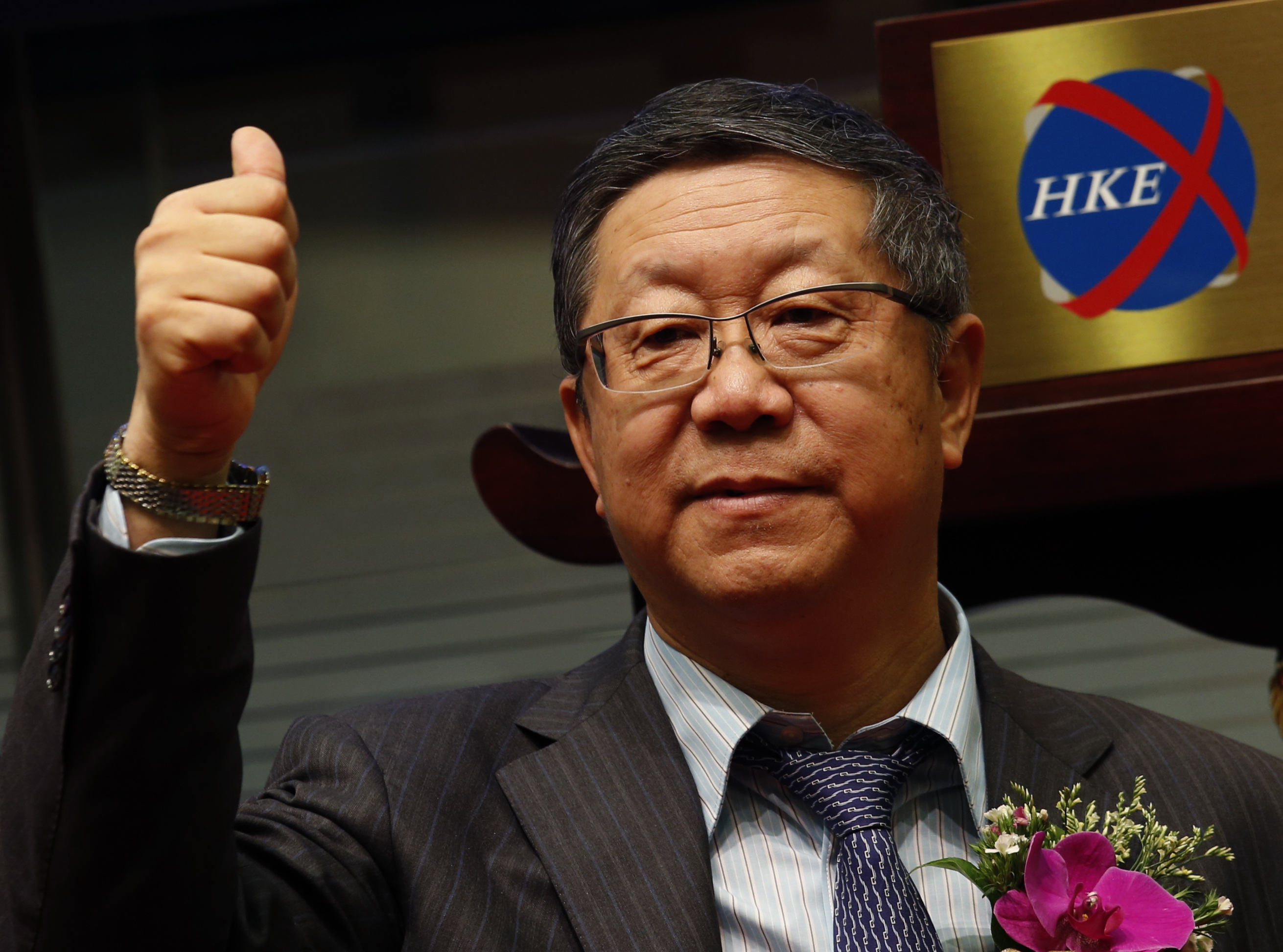 China Everbright Bank's Chairman Tang gestures during the debut of the bank at the Hong Kong Stock Exchange