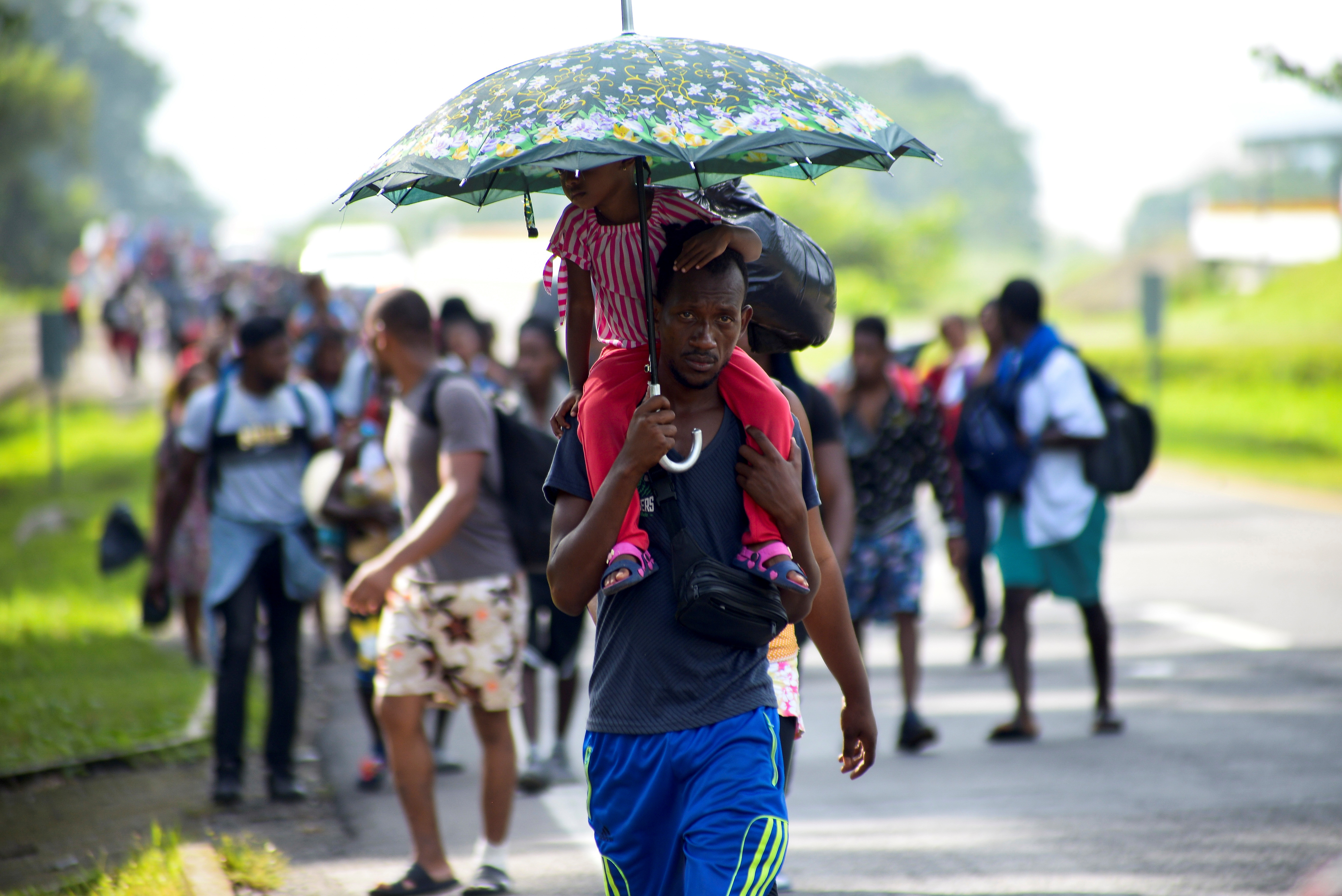 Migrants and asylum seekers from Central America and the Caribbean walk in a caravan headed to the Mexican capital to apply for asylum and refugee status, on a highway in Escuintla, in Chiapas state, Mexico August 31, 2021. REUTERS/Jacob Garcia